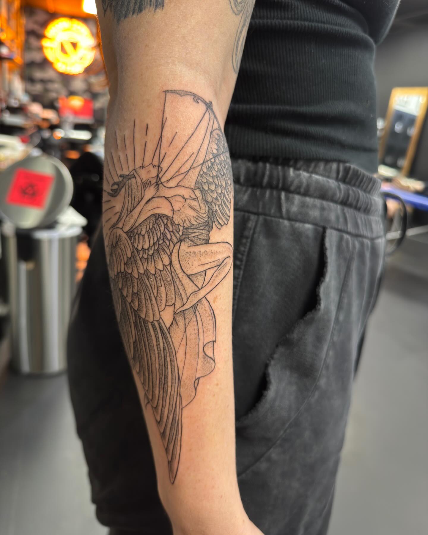 Angel with wings dotwork tattoo on the forearm by Marissa Losier