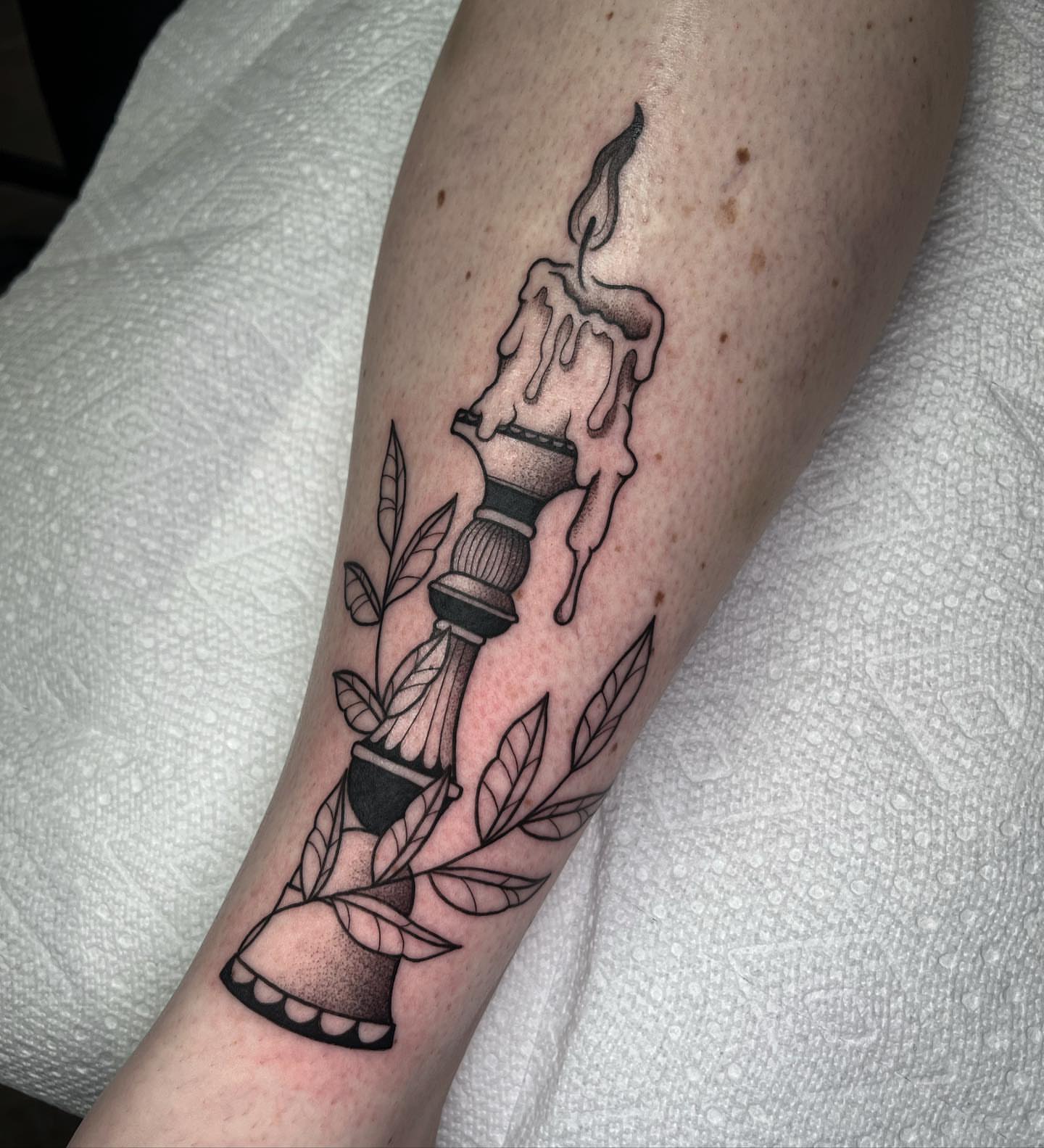 Candle black and grey tattoo on the forearm by Ty’s Tattoos