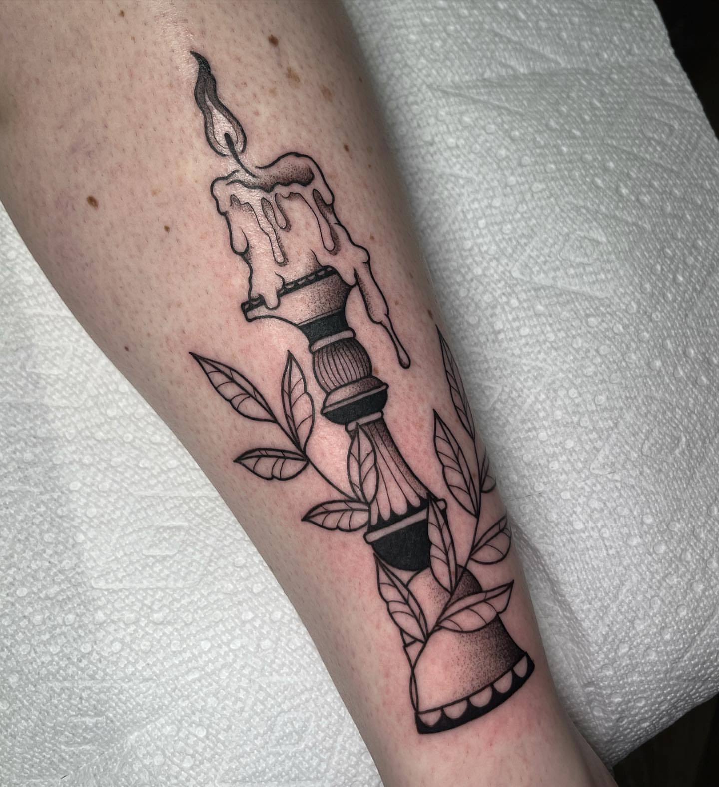 Candle black and grey tattoo on the forearm by Ty’s Tattoos