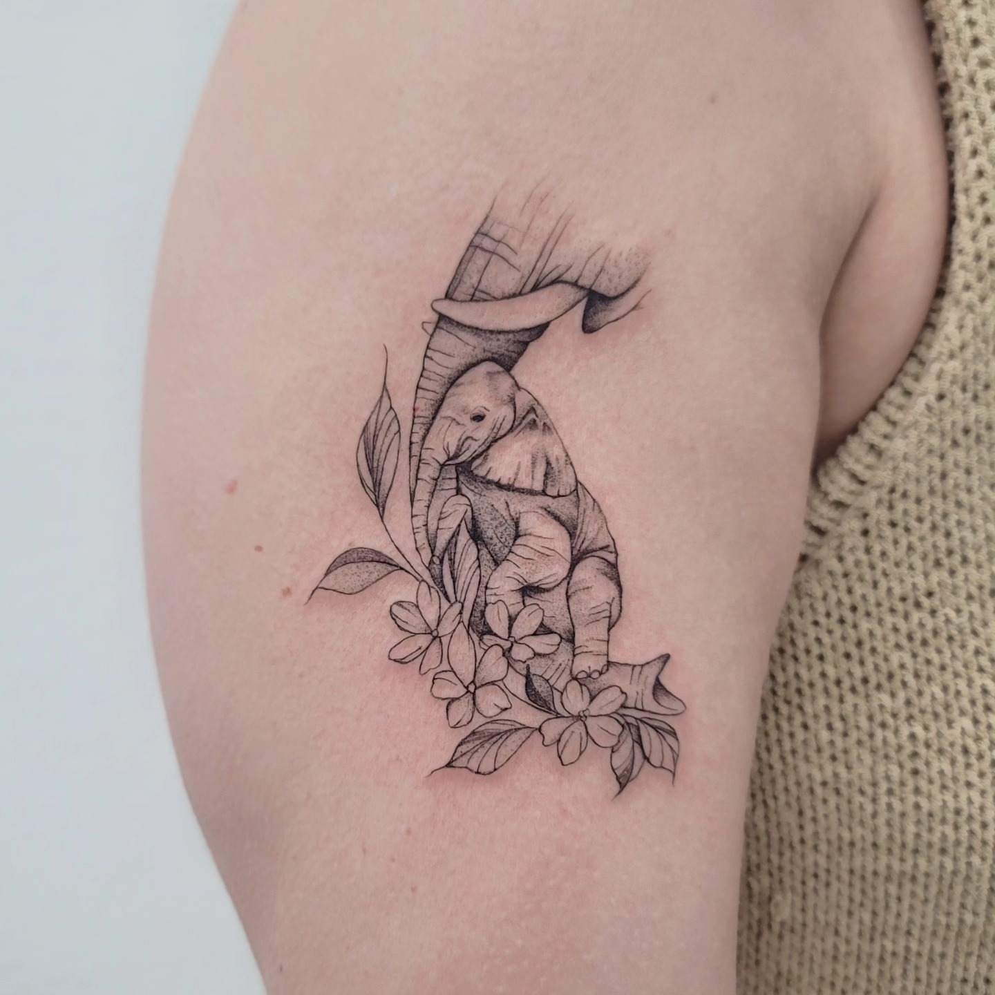 Elephant and flowers realism tattoo on the forearm by Las Vegas Fine Line Tattoos