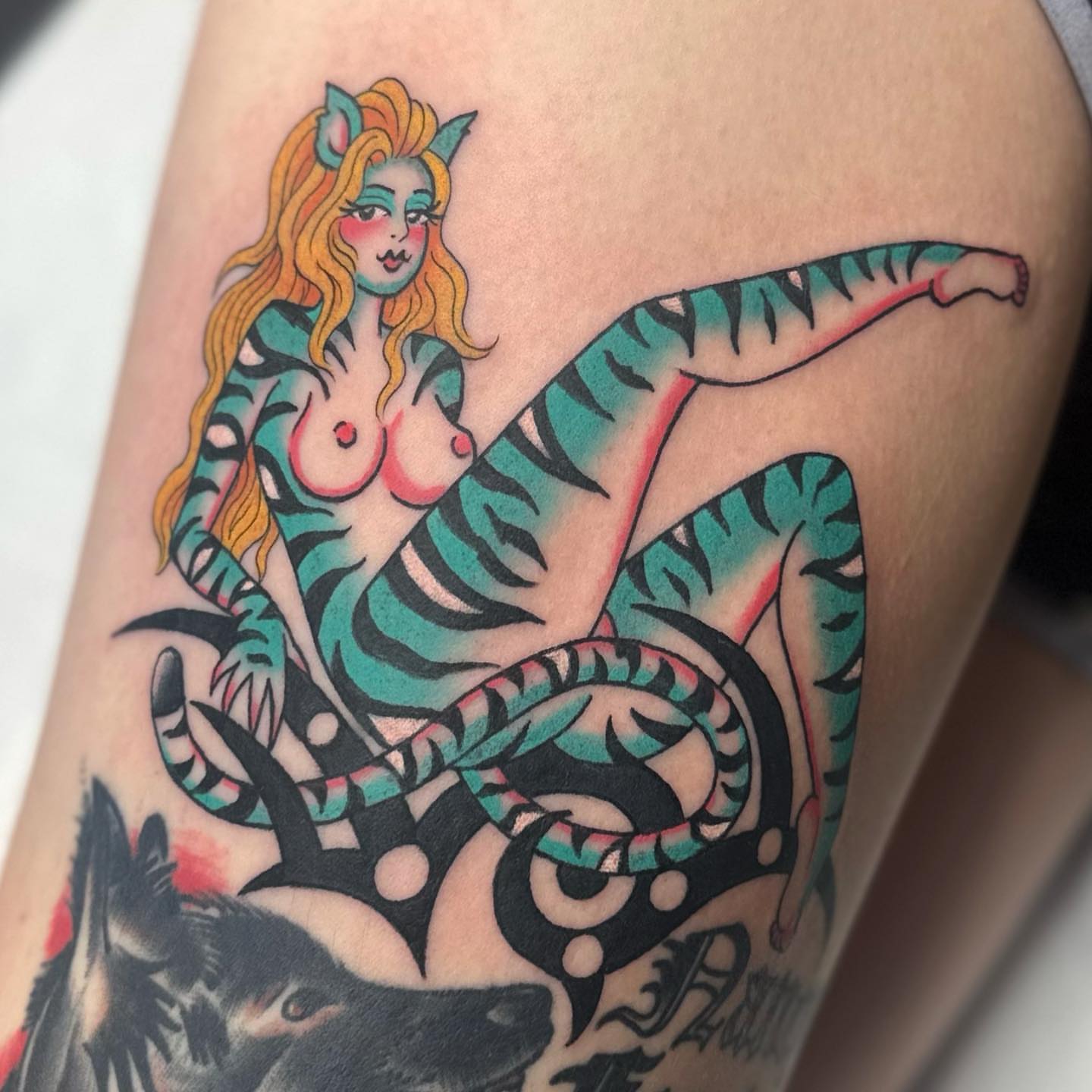 Woman riding tiger American traditional tattoo on the thigh by Alexa Wolfkiel