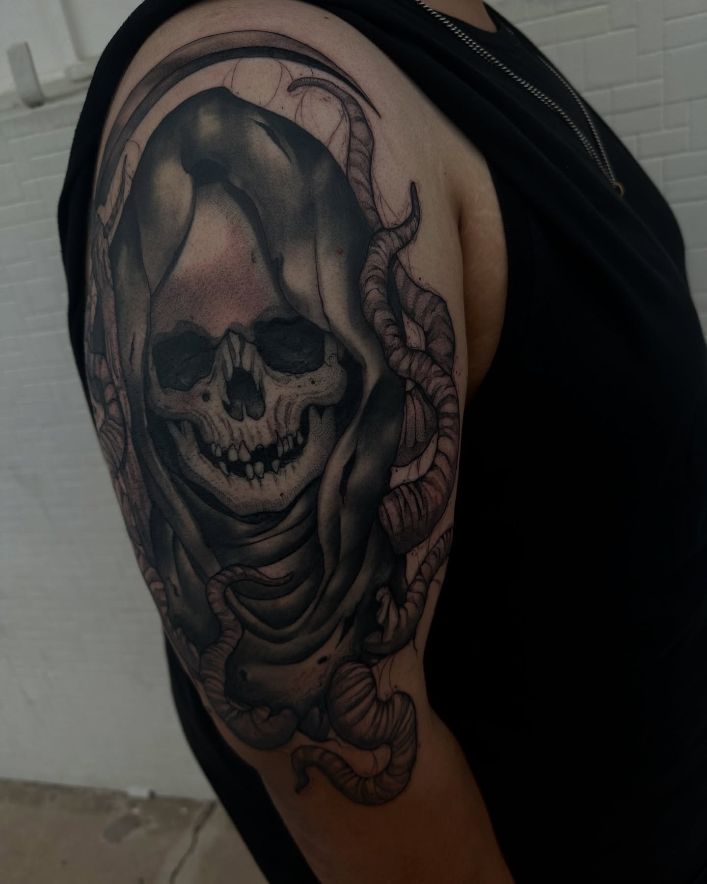 Skull and snakes realism tattoo on the shoulder by Juan Vega (tony)