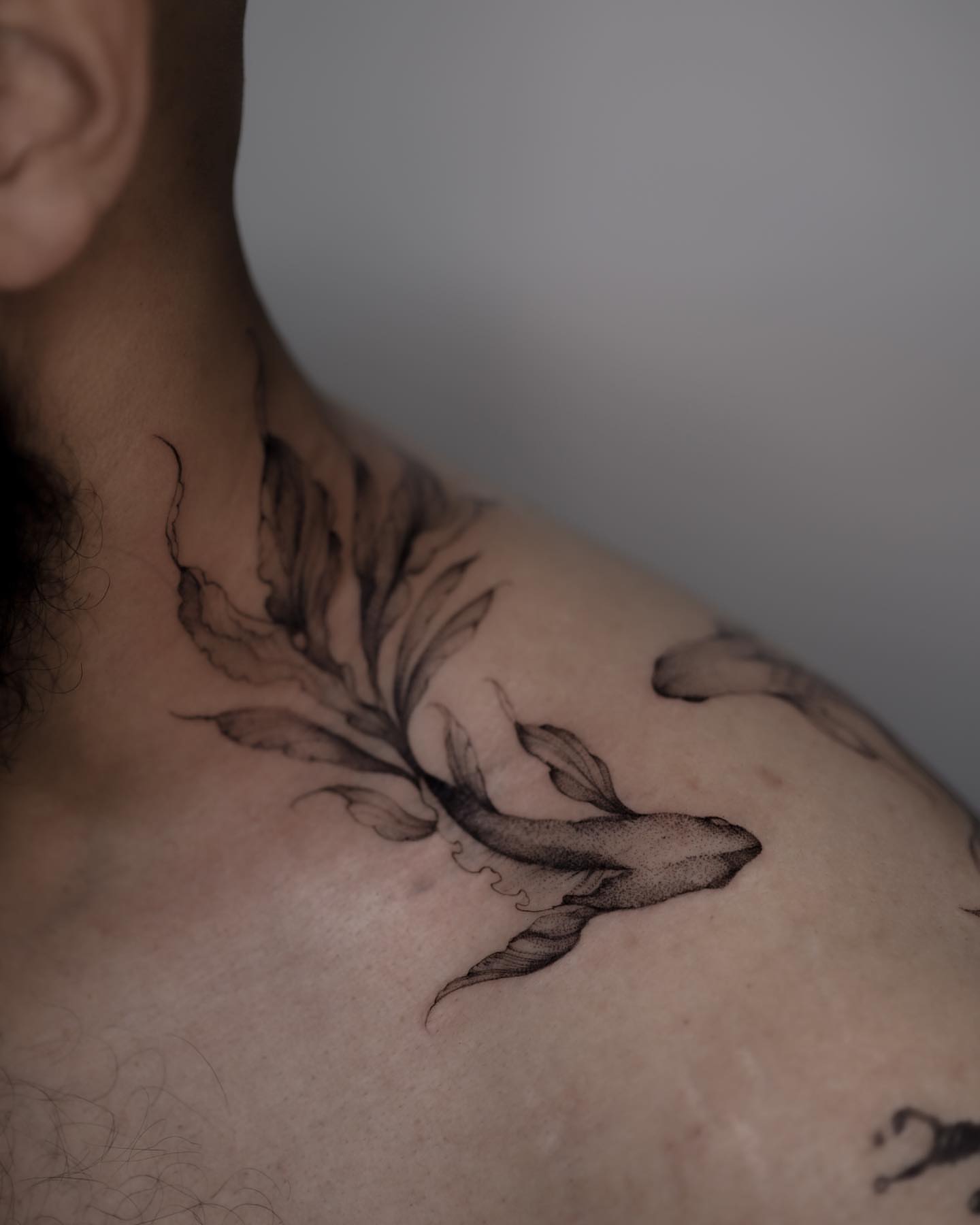 Whale and leaves black and grey tattoo on the chest by Tattoo artist in Boston
