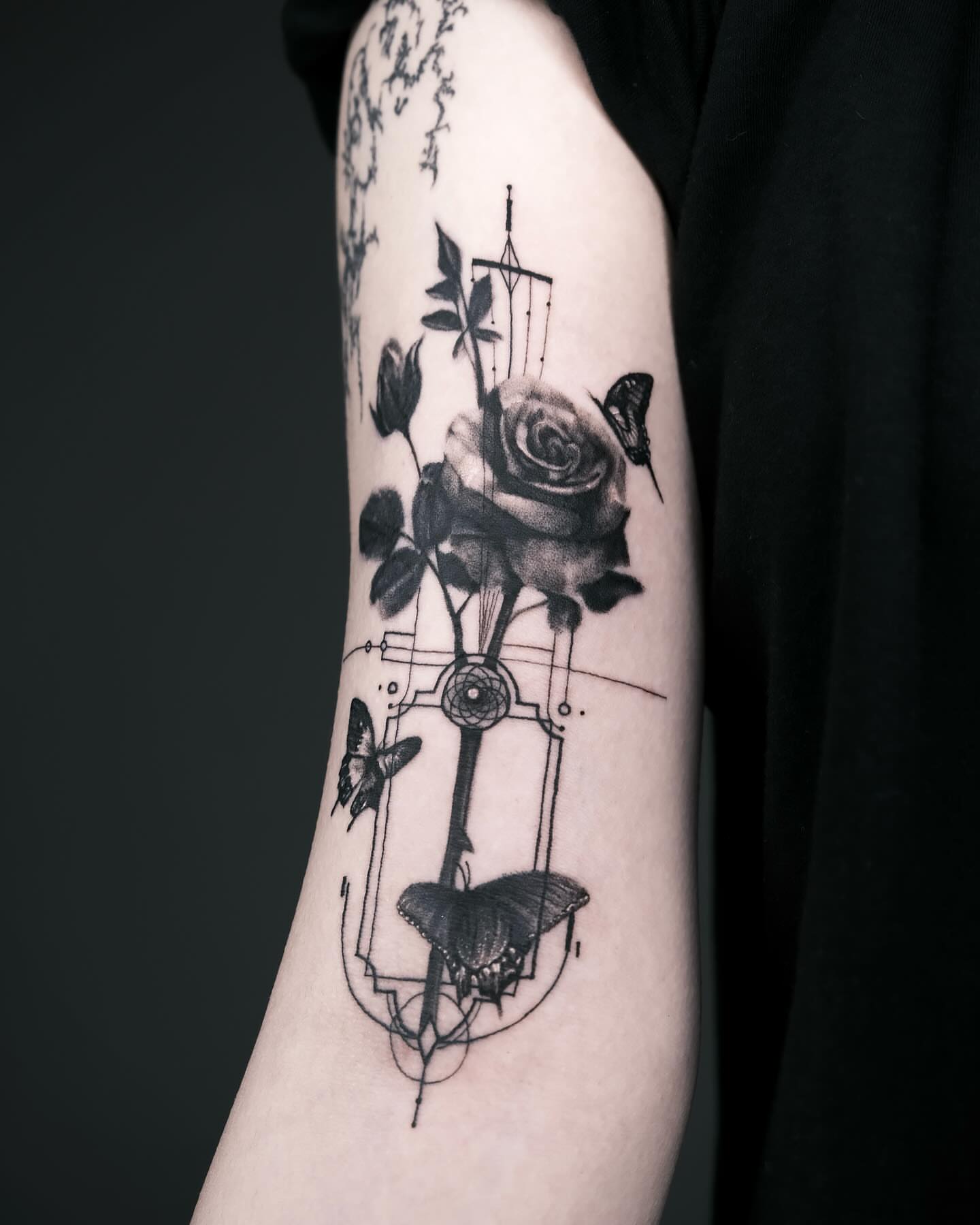 Rose and butterflies geometric tattoo on the forearm by Seraph Geometry