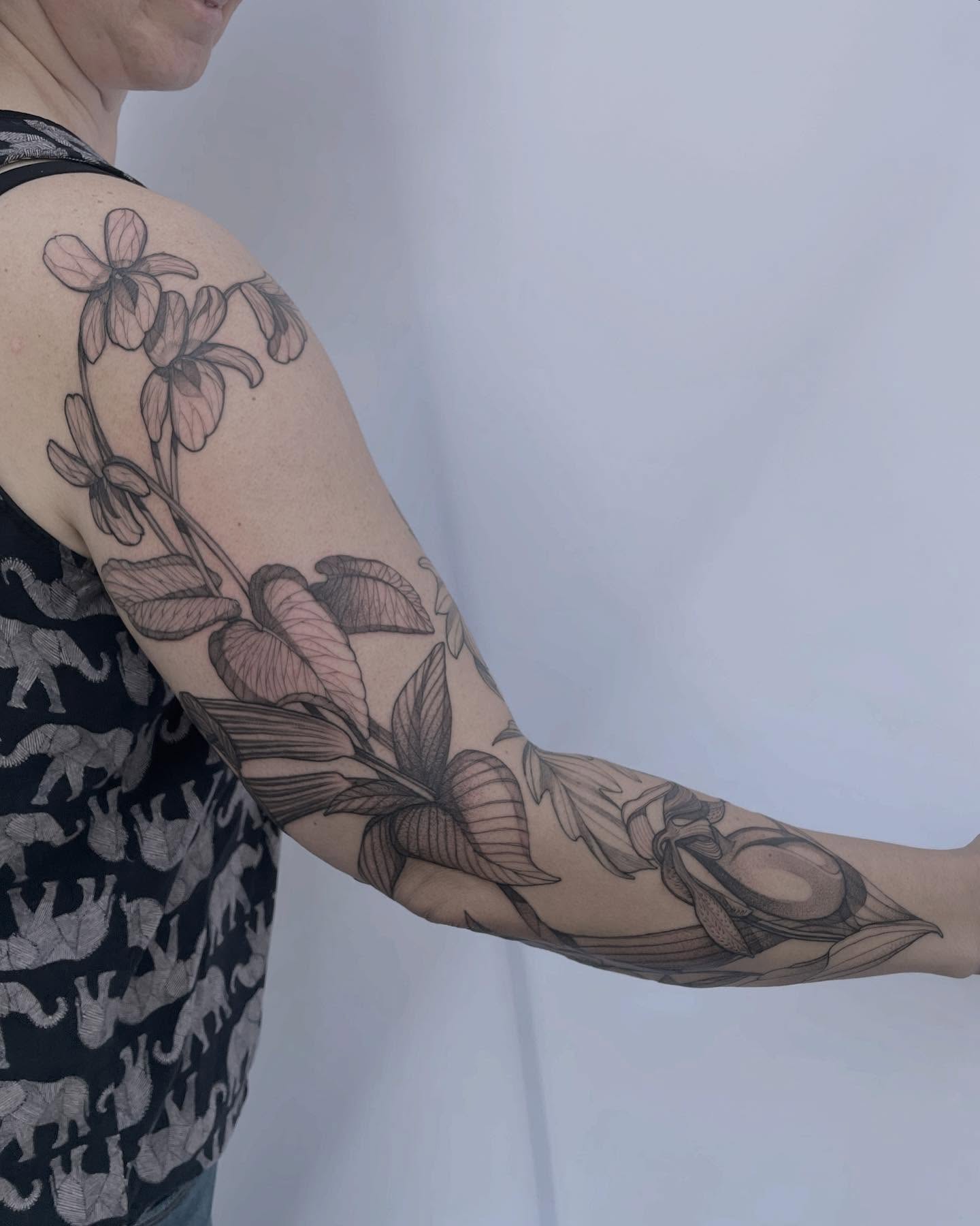 Floral arrangement black and grey tattoo on the forearm by Carol Jacky