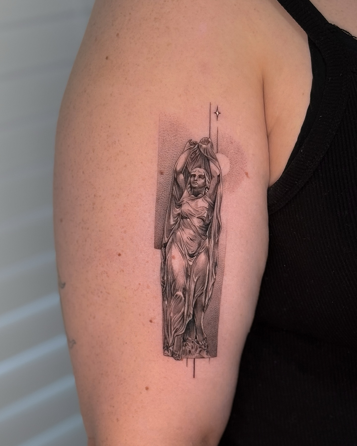 Statue black and grey tattoo on the upper arm by ♡ 𝕍𝕚𝕔𝕥𝕠𝕣𝕚𝕒 ℍ𝕠𝕝𝕞𝕖𝕤 ♡, Avon, Ohio