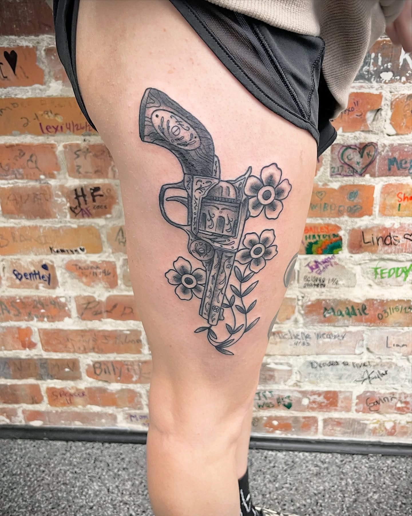 Revolver and flowers black and grey tattoo on the thigh by Will McCoy (Tattooist), Murray, Utah