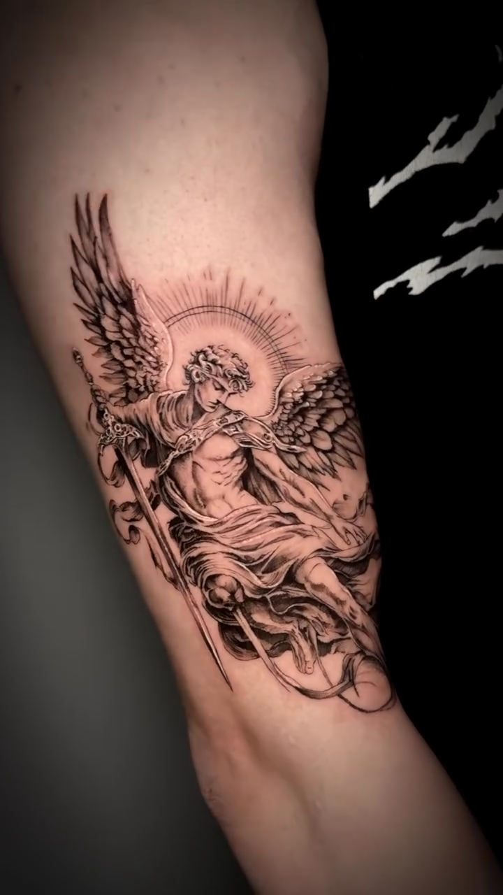 Angel with sword and shield realism tattoo on the forearm by Nyc Tattoo Manhattan