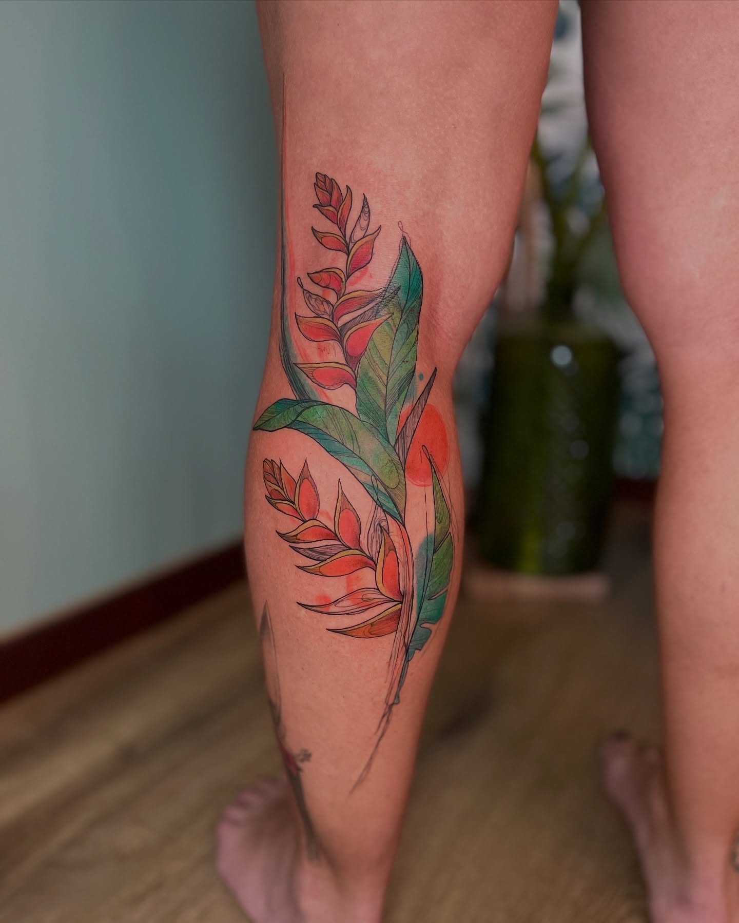 Bird of paradise flowers watercolor tattoo on the calf by Lo Boverod - La Passoire  - Tatoueuse -