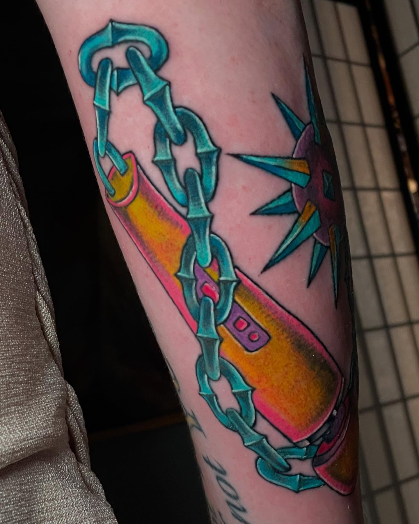 Chains and starburst geometric tattoo on the forearm by Madison ‘Maddog’ Stewart