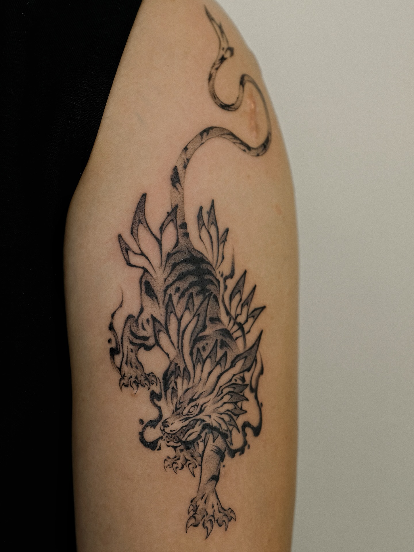 Dragon black and grey tattoo on the forearm by Xiao Lun