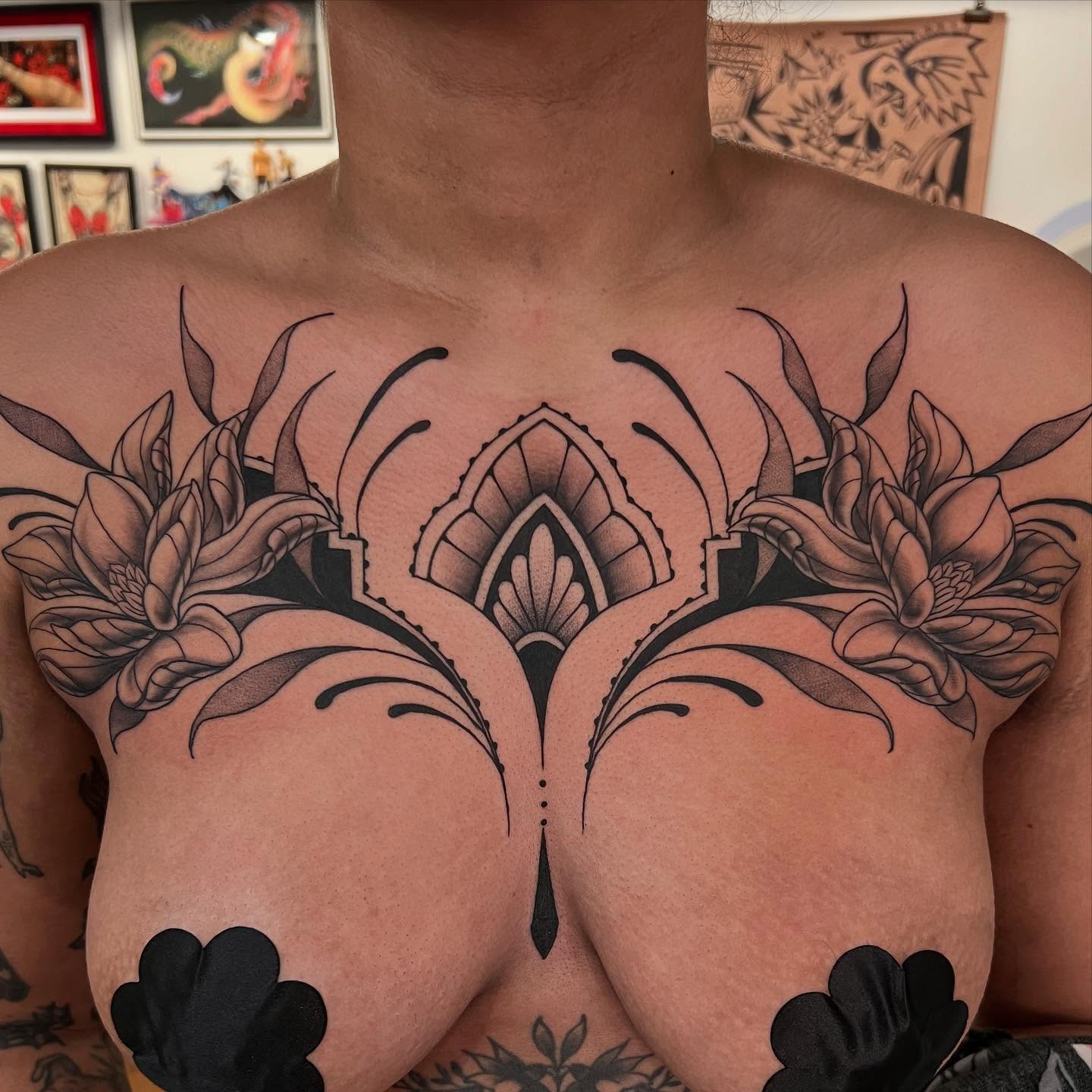 Lotus flowers geometric tattoo on the chest by Tasha Venola, Bellingham, Washington