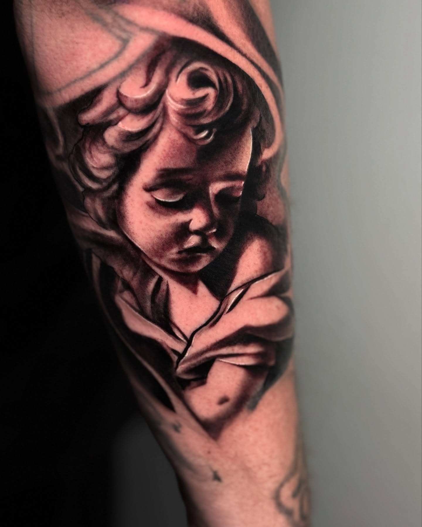 Child's head realism tattoo on the forearm by Jesse Temores