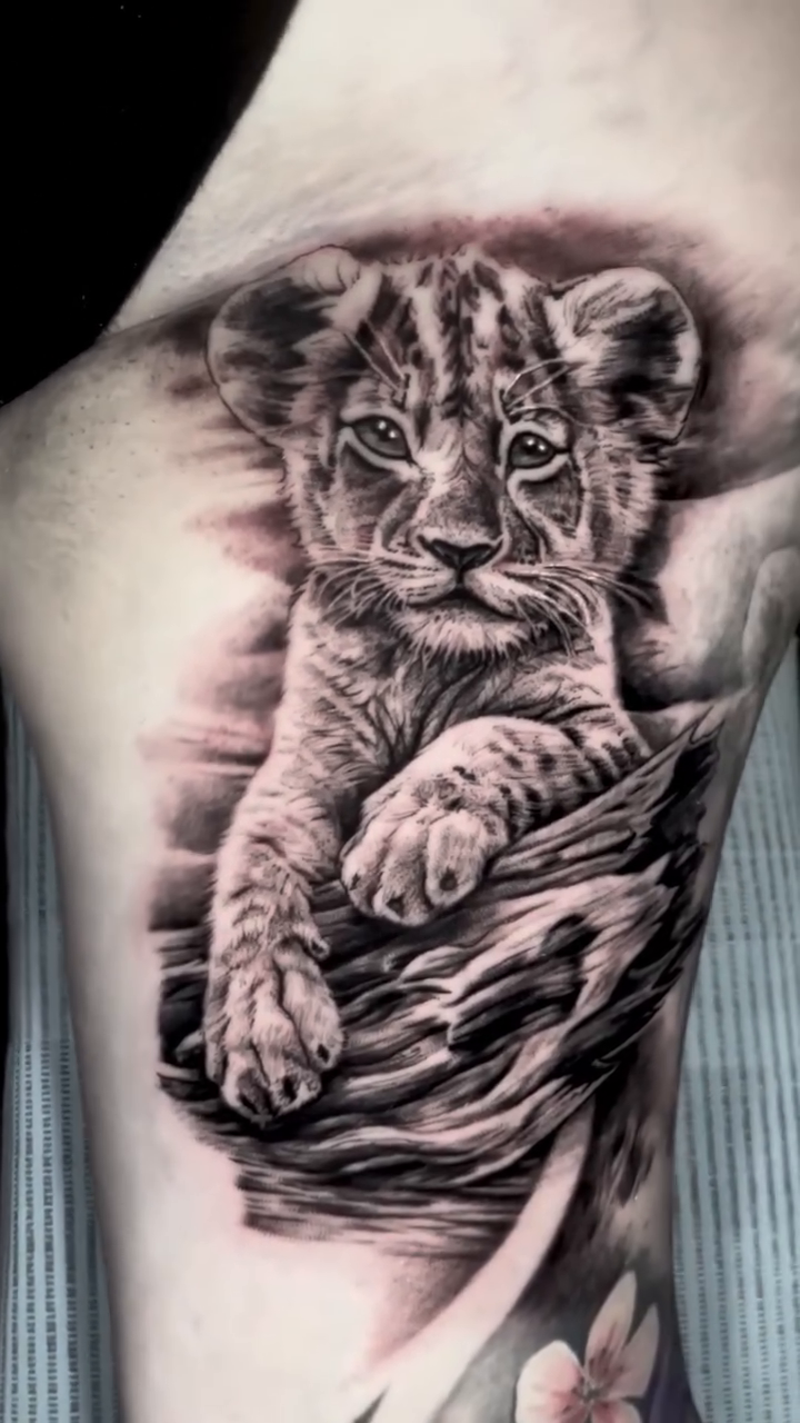 Lion cub realism tattoo by James Moyer
