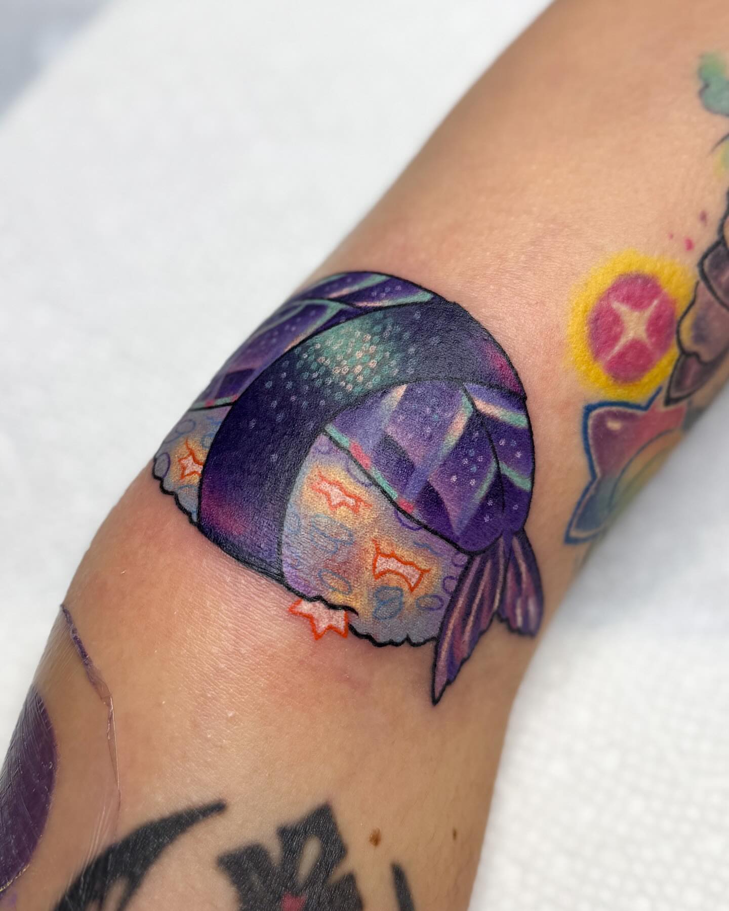 Space-themed fish dotwork tattoo on the forearm by Janine Ramos