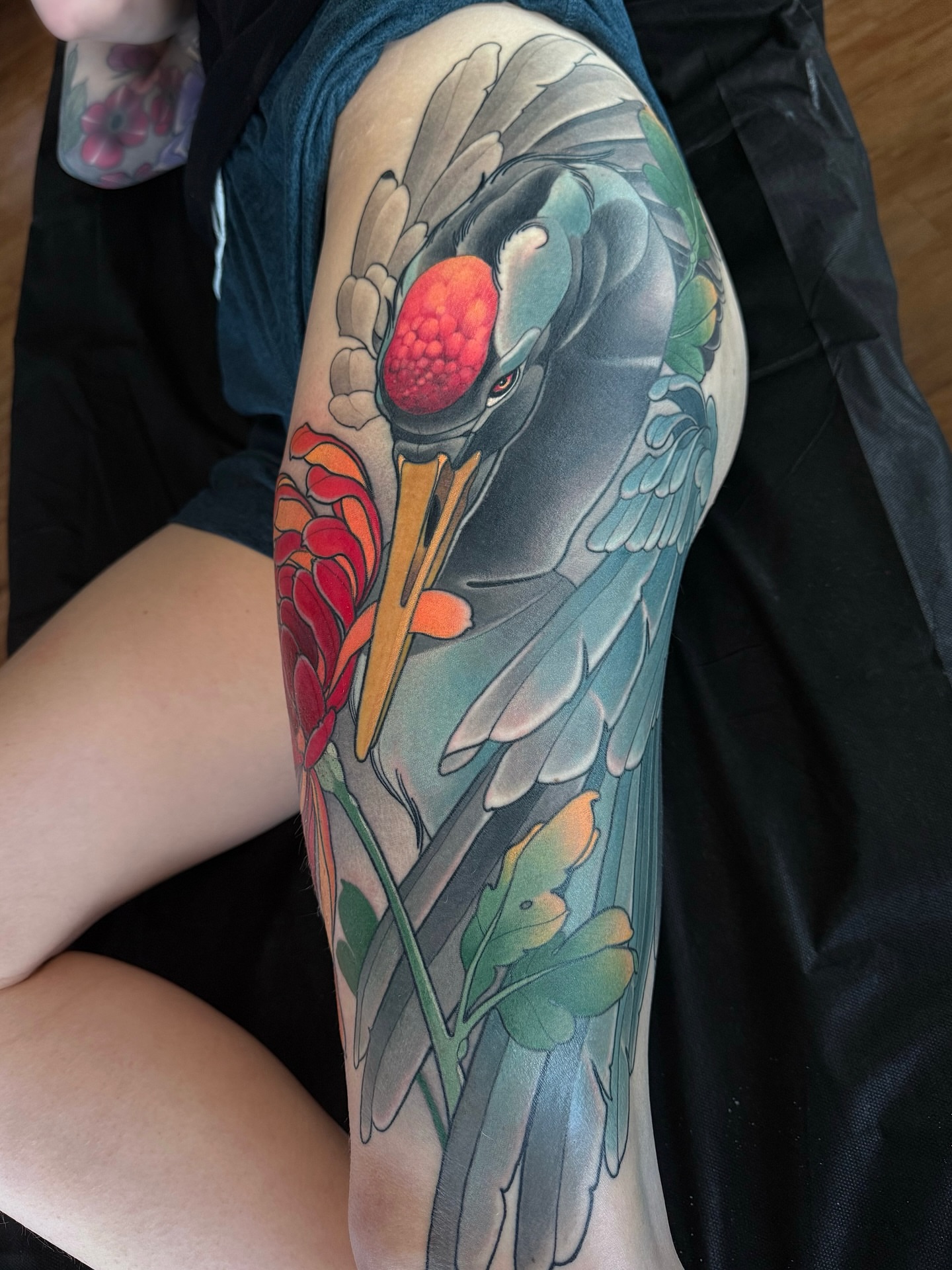 Crane and flowers japanese irezumi tattoo on the thigh by Anne Cornelson