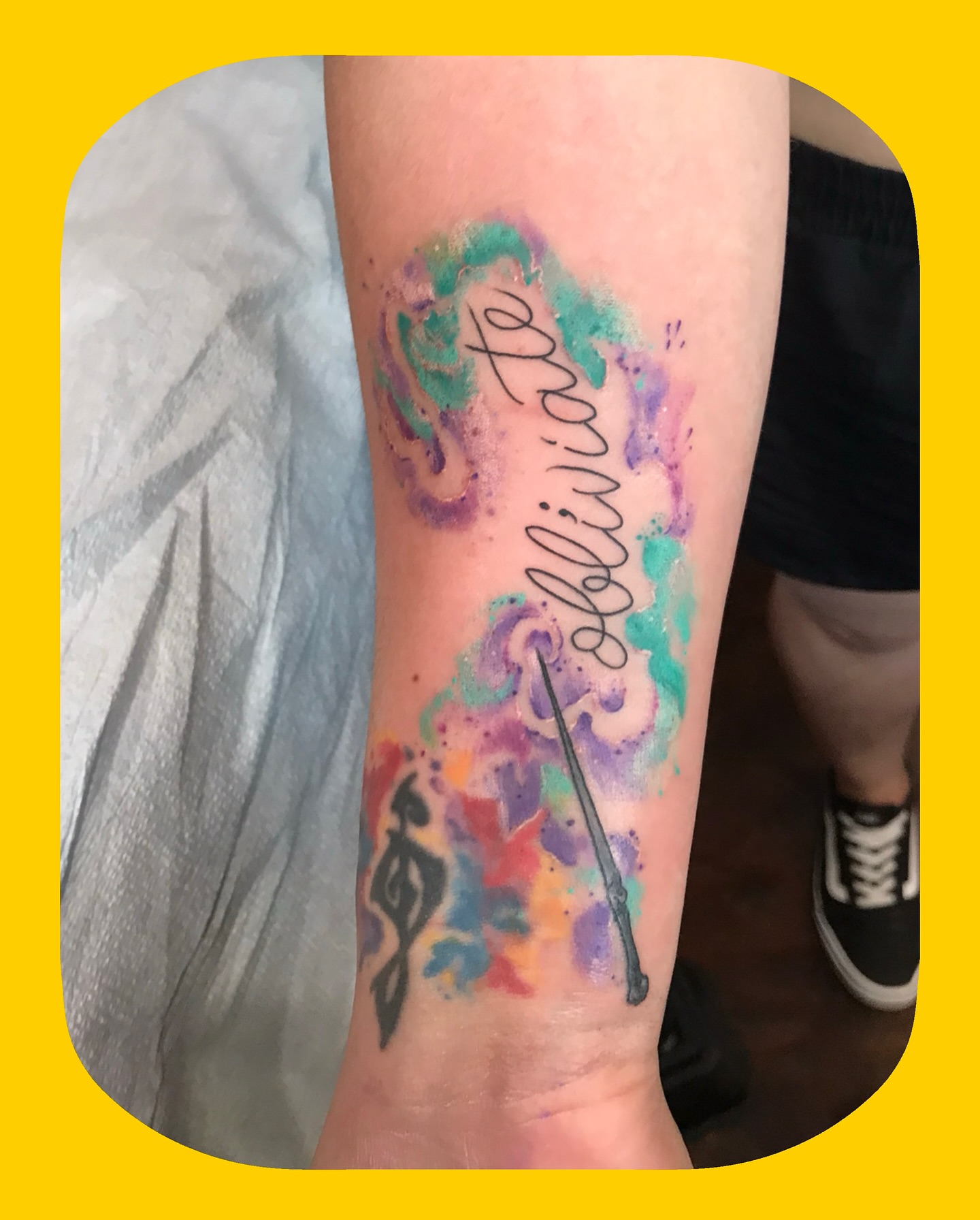 Watercolor swirls and wand watercolor tattoo on the forearm by Chris Chapman