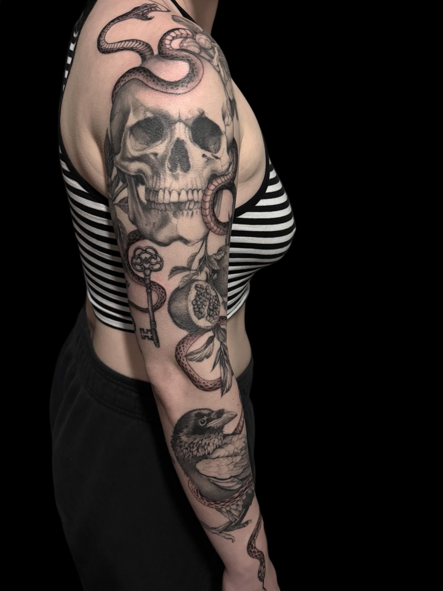 Skull and snake realism tattoo on the upper arm by Brennan Walker, Orem, Utah