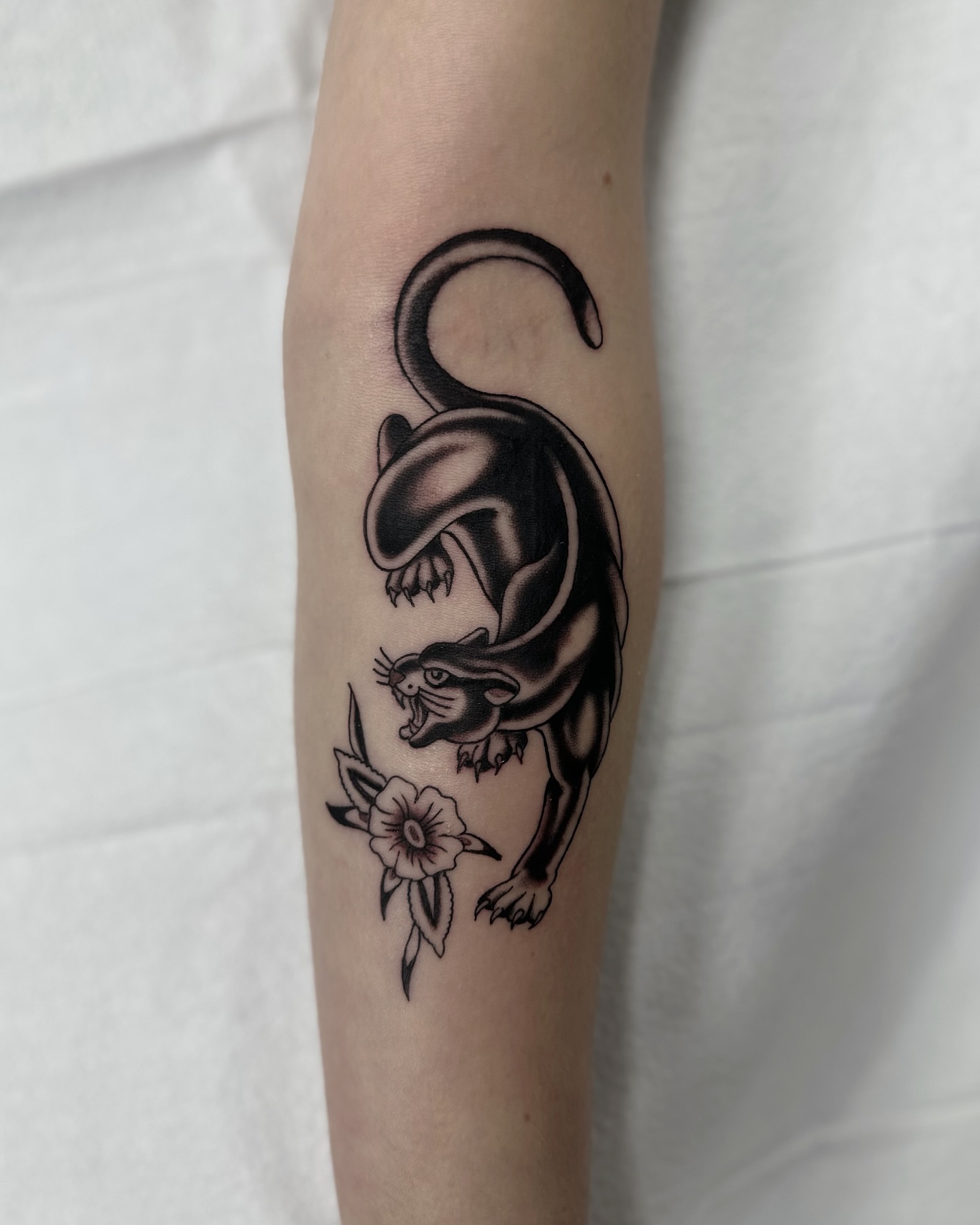 Panther and flower black and grey tattoo on the forearm by Nicholas Lee, San Francisco, California