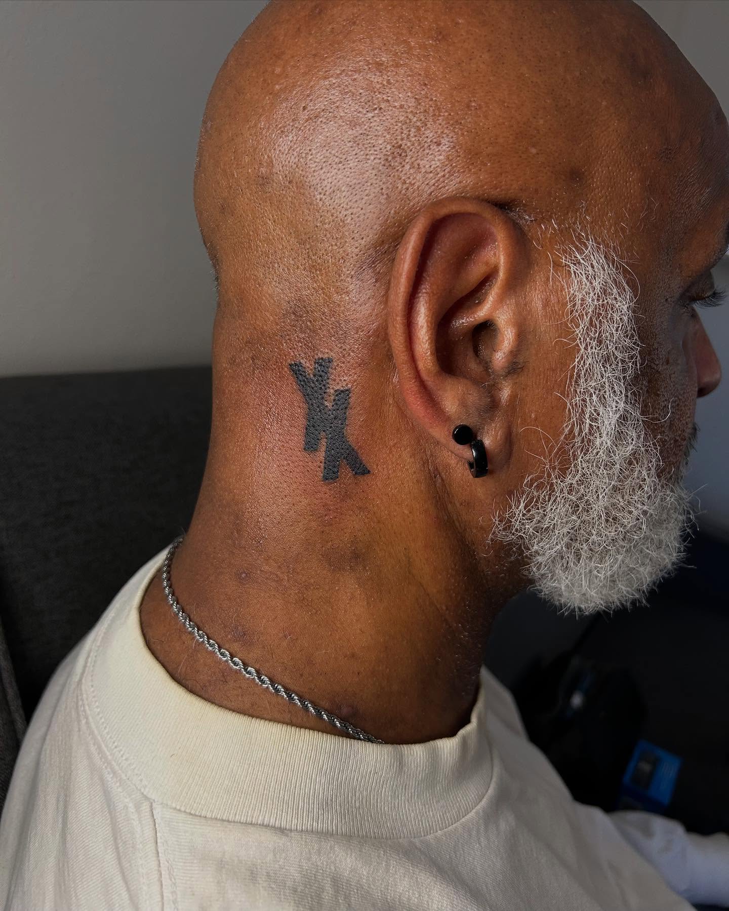 Cross black and grey tattoo on the neck by Airika Edwards