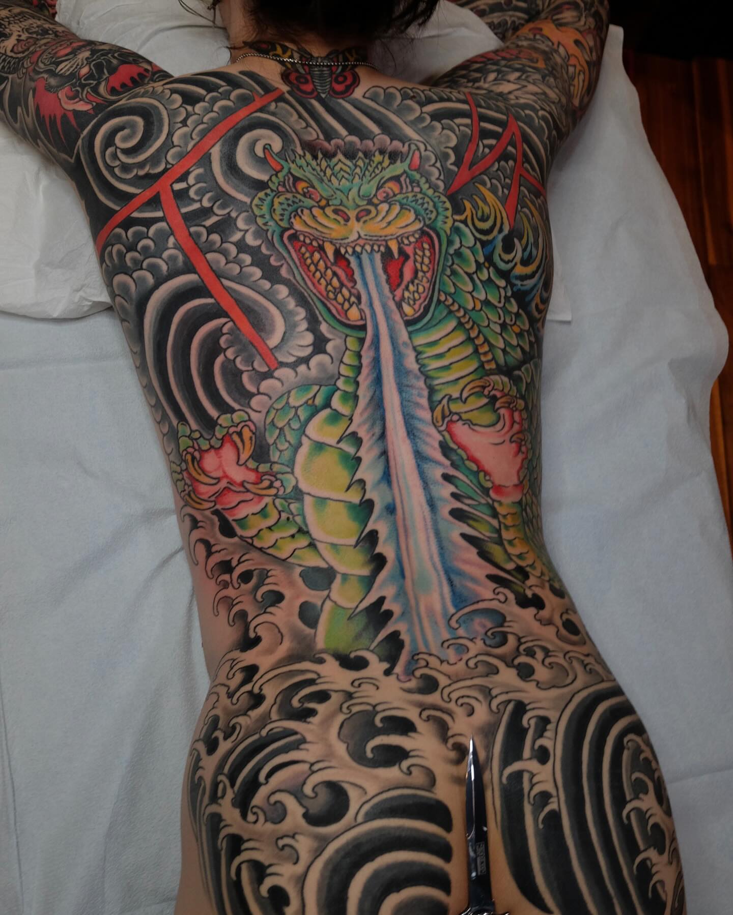 Dragon and waves japanese irezumi tattoo on the back by Zac Blevins