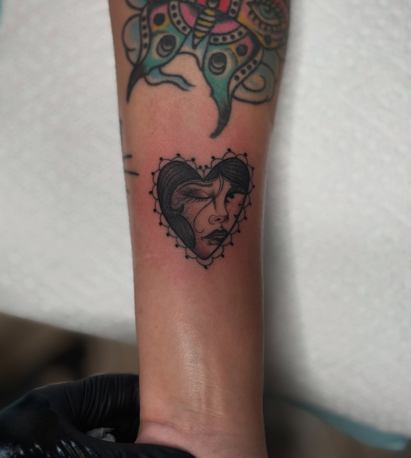 Heart with woman's face dotwork tattoo on the forearm by K9