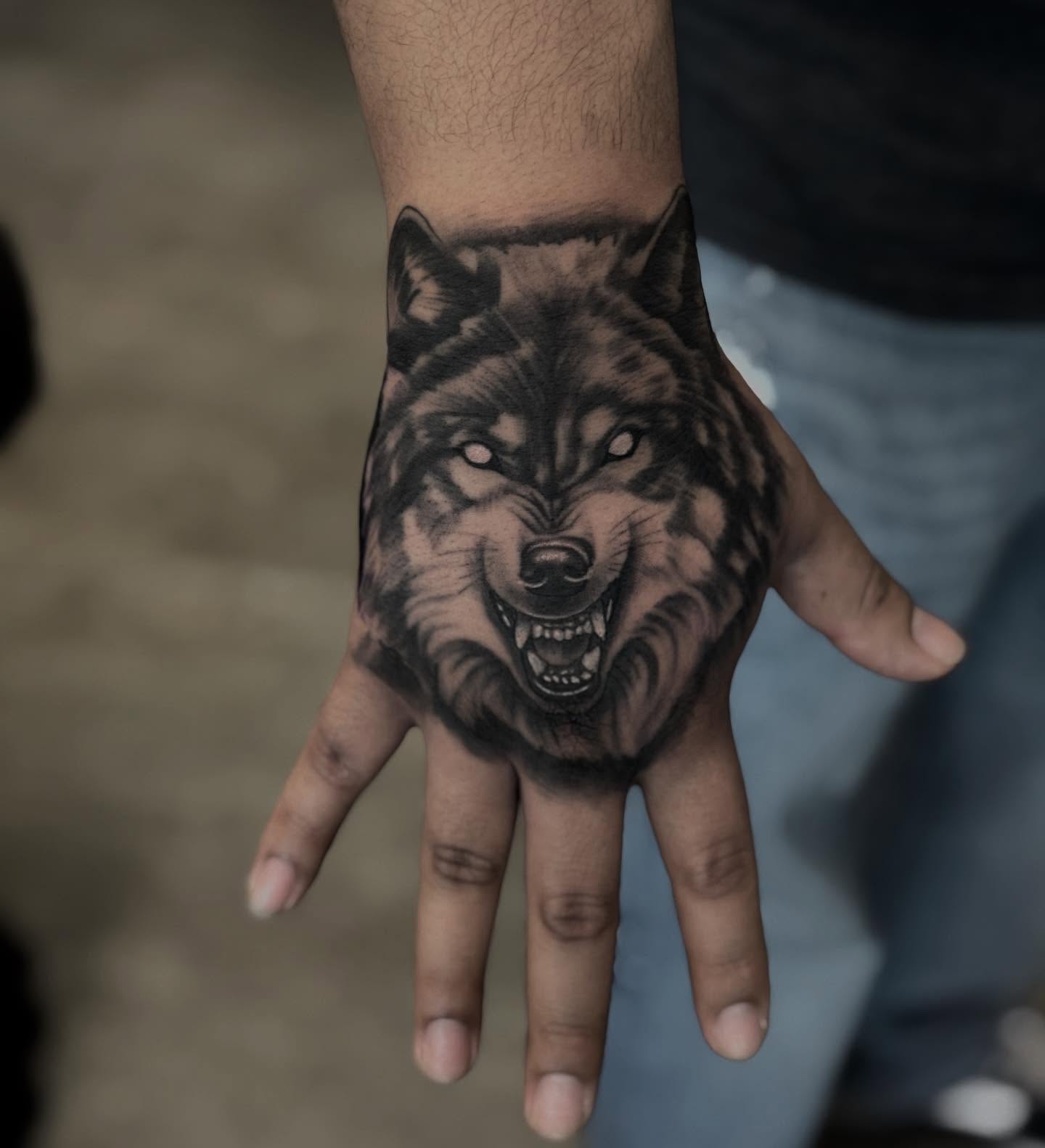 Wolf realism tattoo on the hand by Aaron Carey, Salem, Oregon