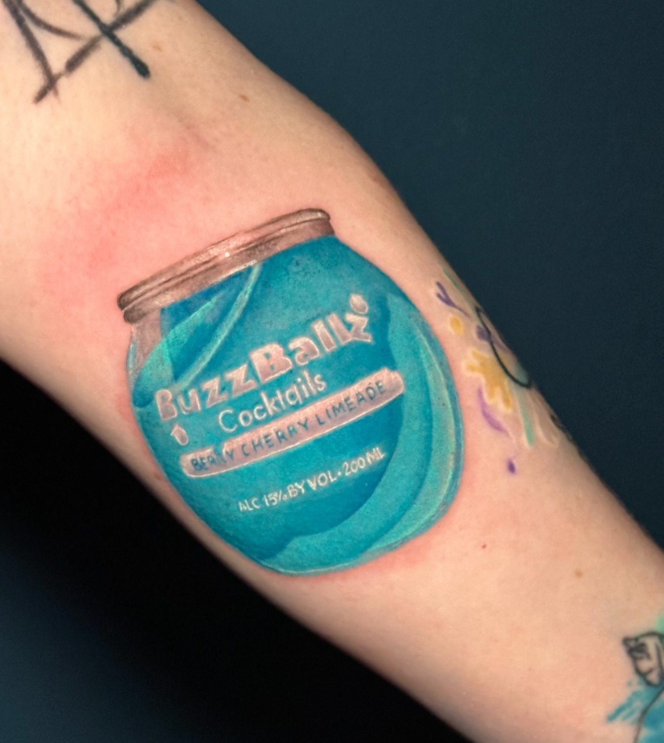 BuzzBallz cocktail bottle realism tattoo on the forearm by Summers
