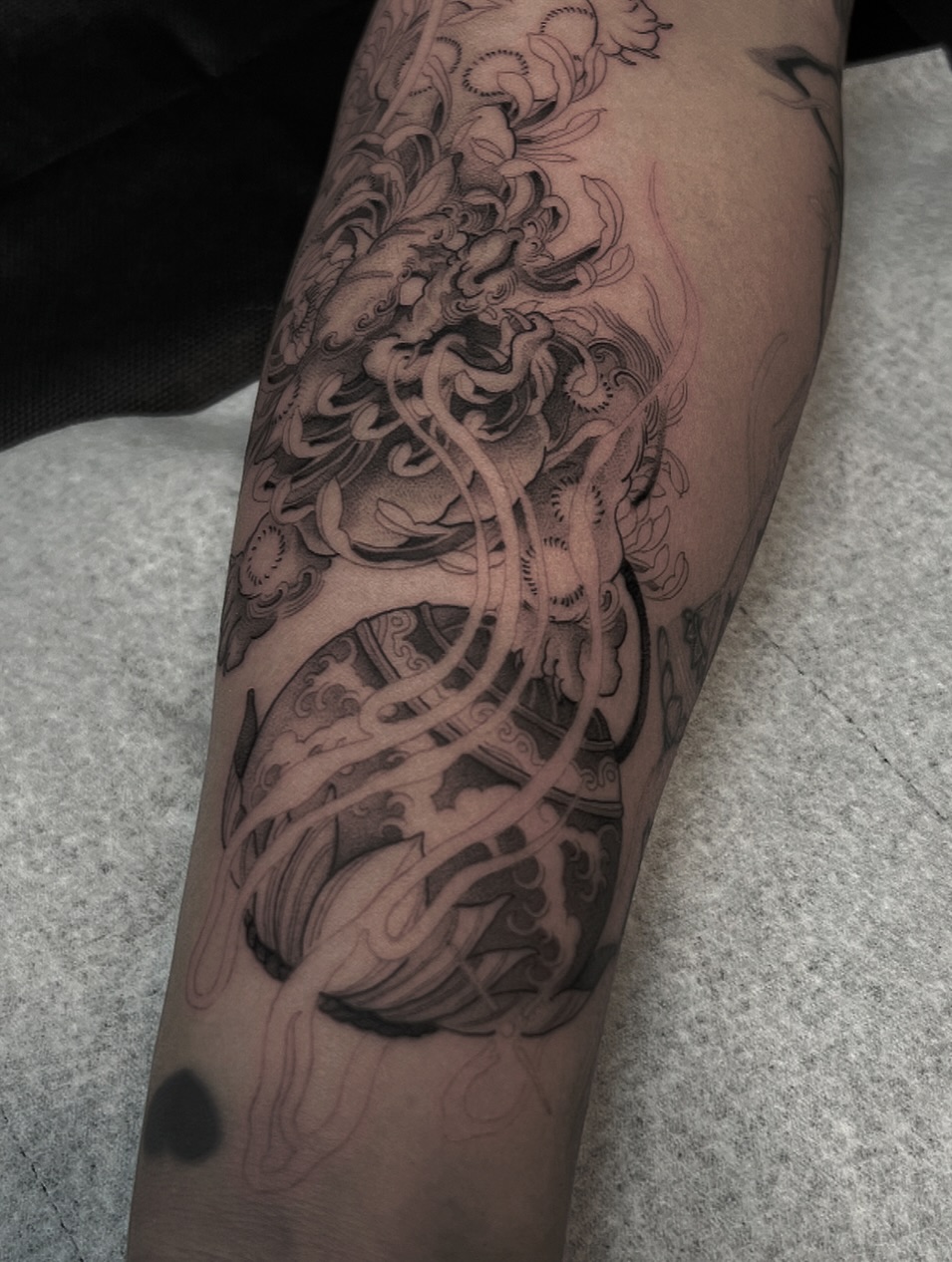 Abstract swirls black and grey tattoo on the forearm by Joshua Hung, Alhambra, California
