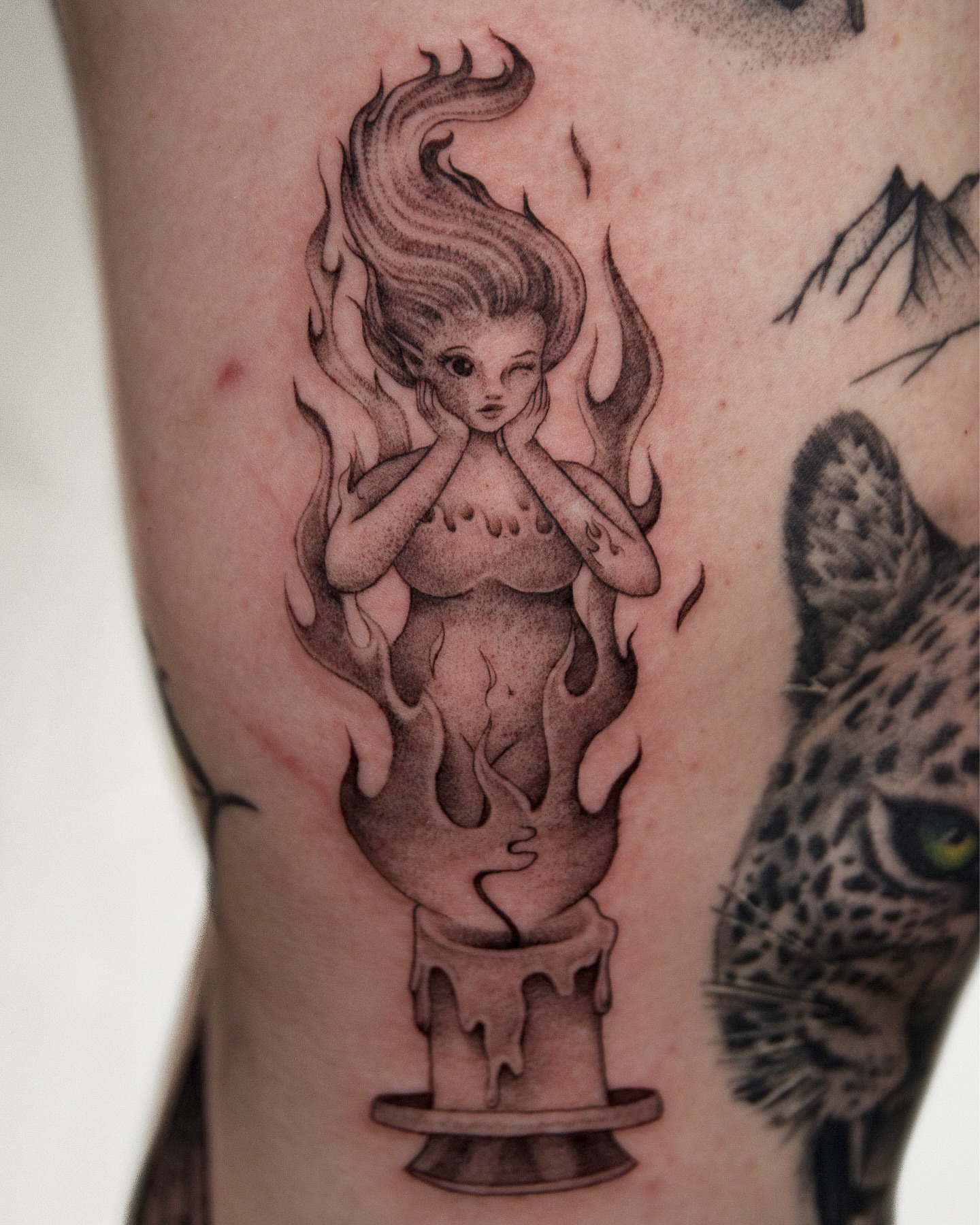 Flaming woman realism tattoo on the forearm by caliope yiannos