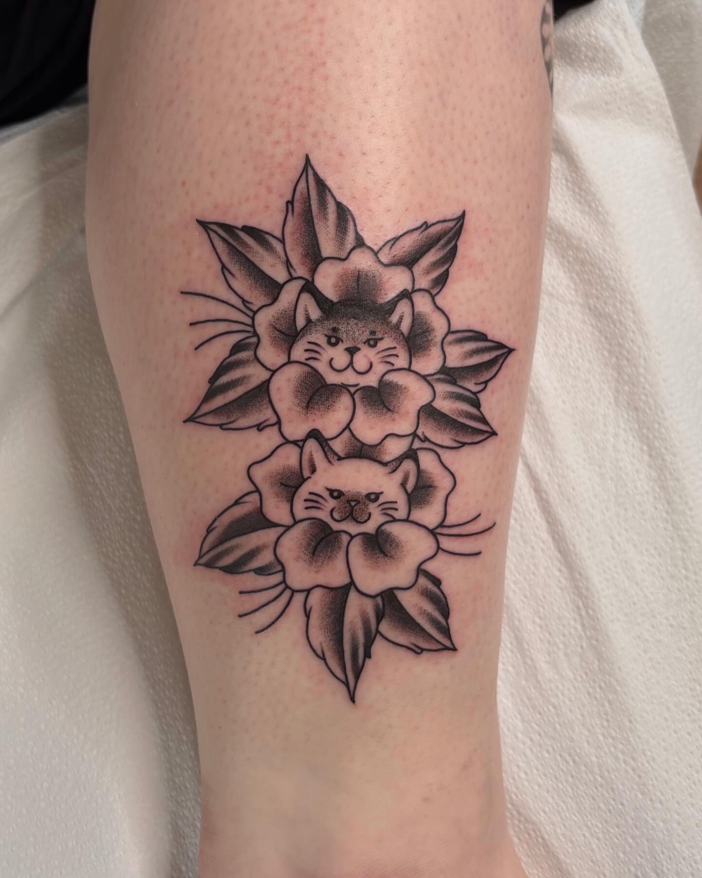 Cat and flowers black and grey tattoo on the forearm by Lily, Eugene, Oregon