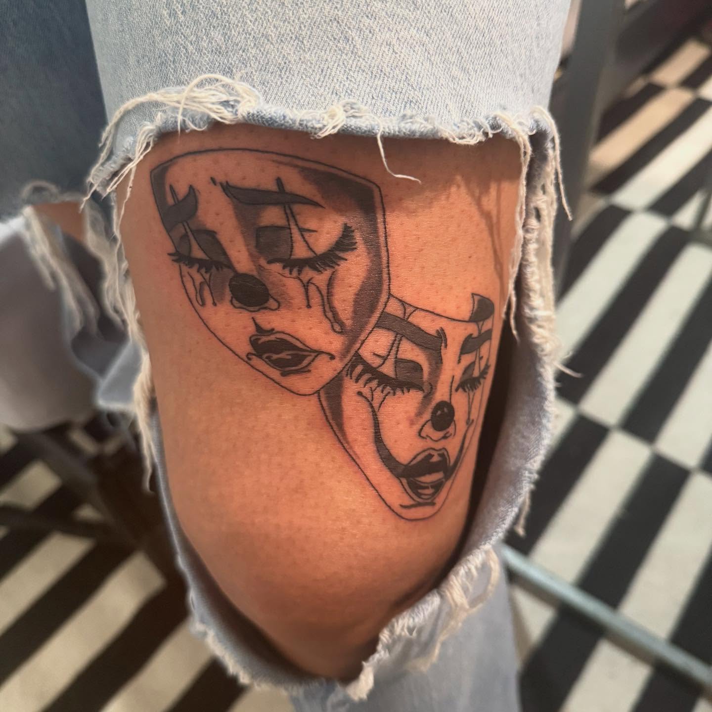 Clown masks black and grey tattoo on the thigh by Noir