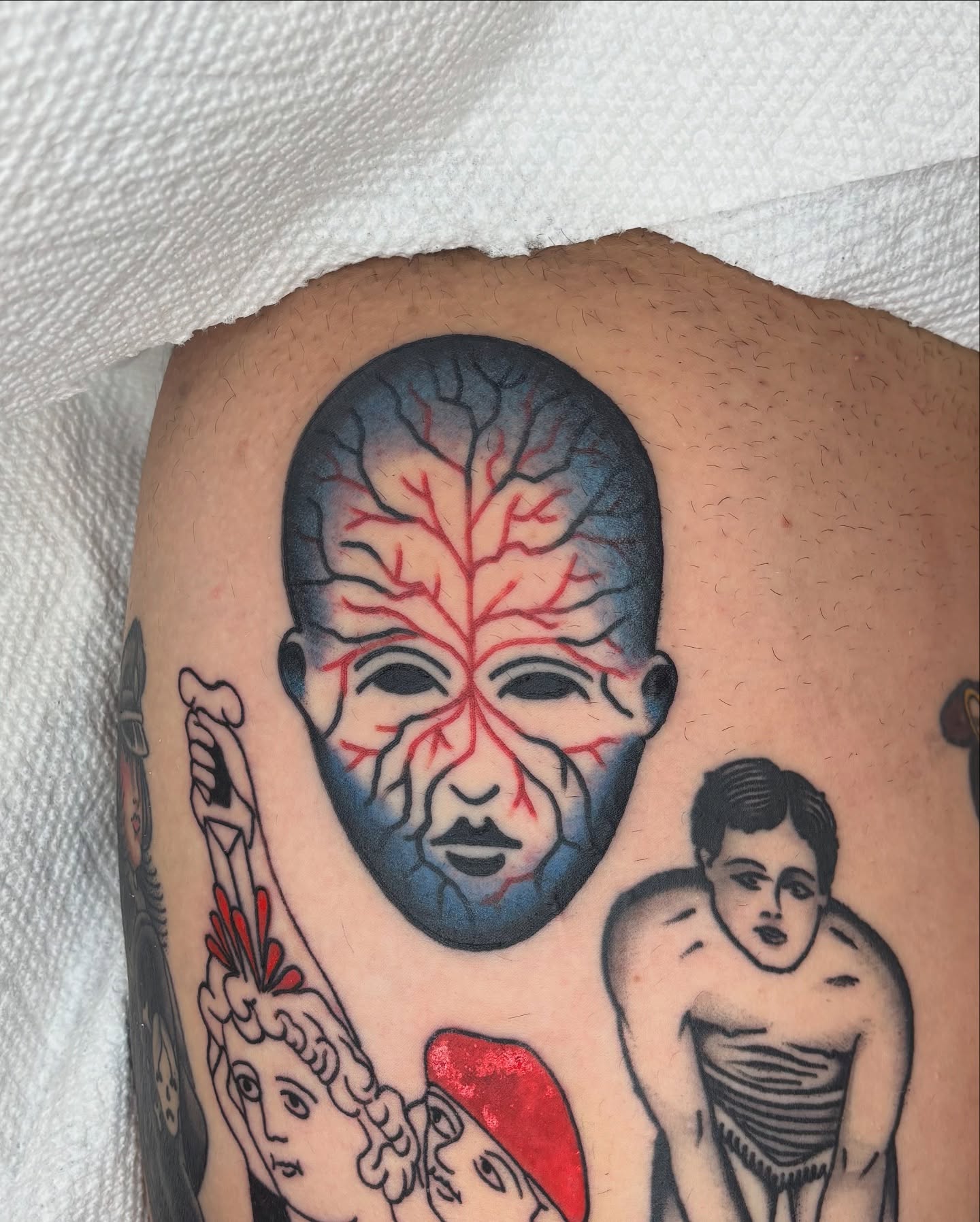 Brain American traditional tattoo on the upper arm by Charlie Dunkel Tattoo