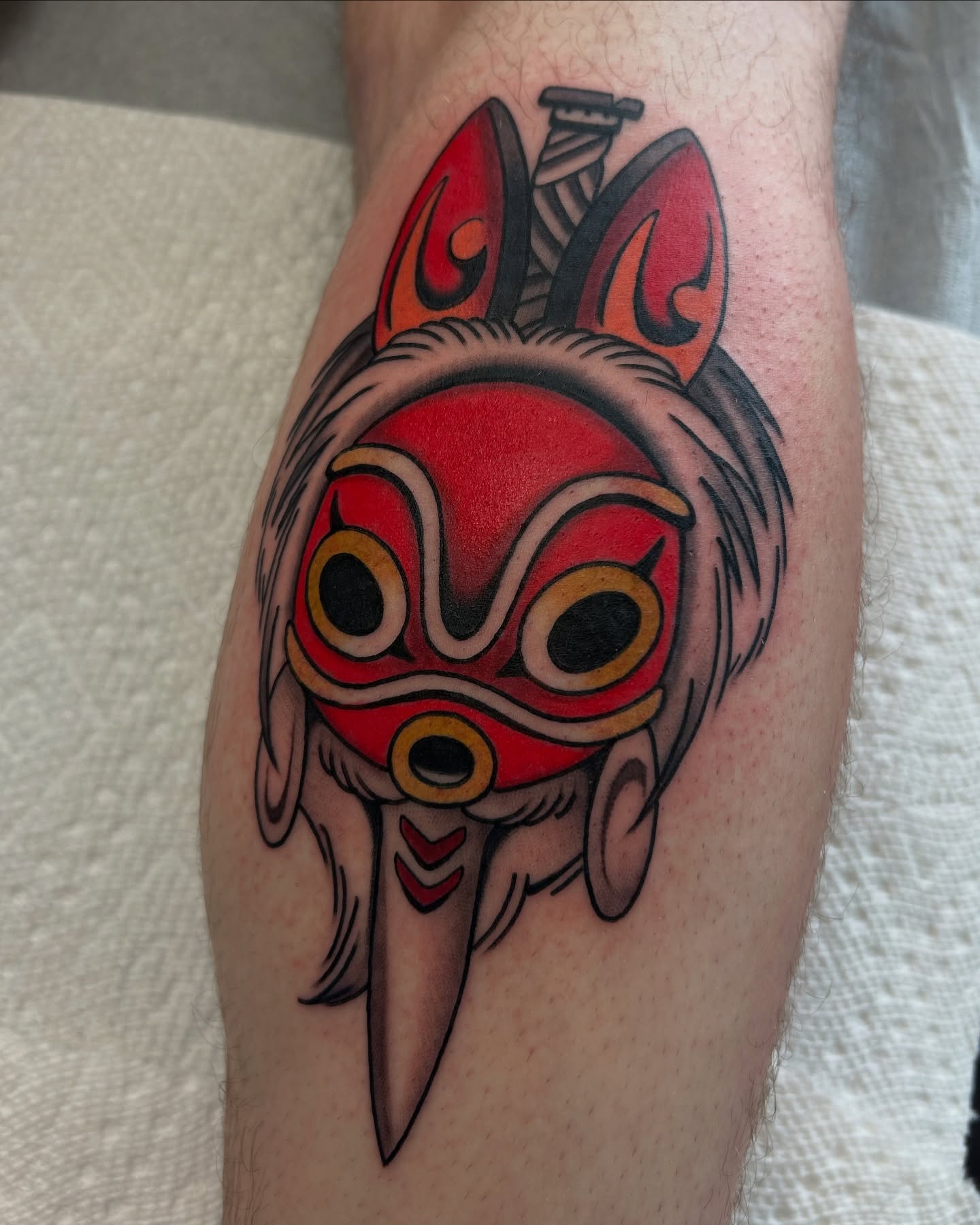 Mask American traditional tattoo on the forearm by Lilly Binns