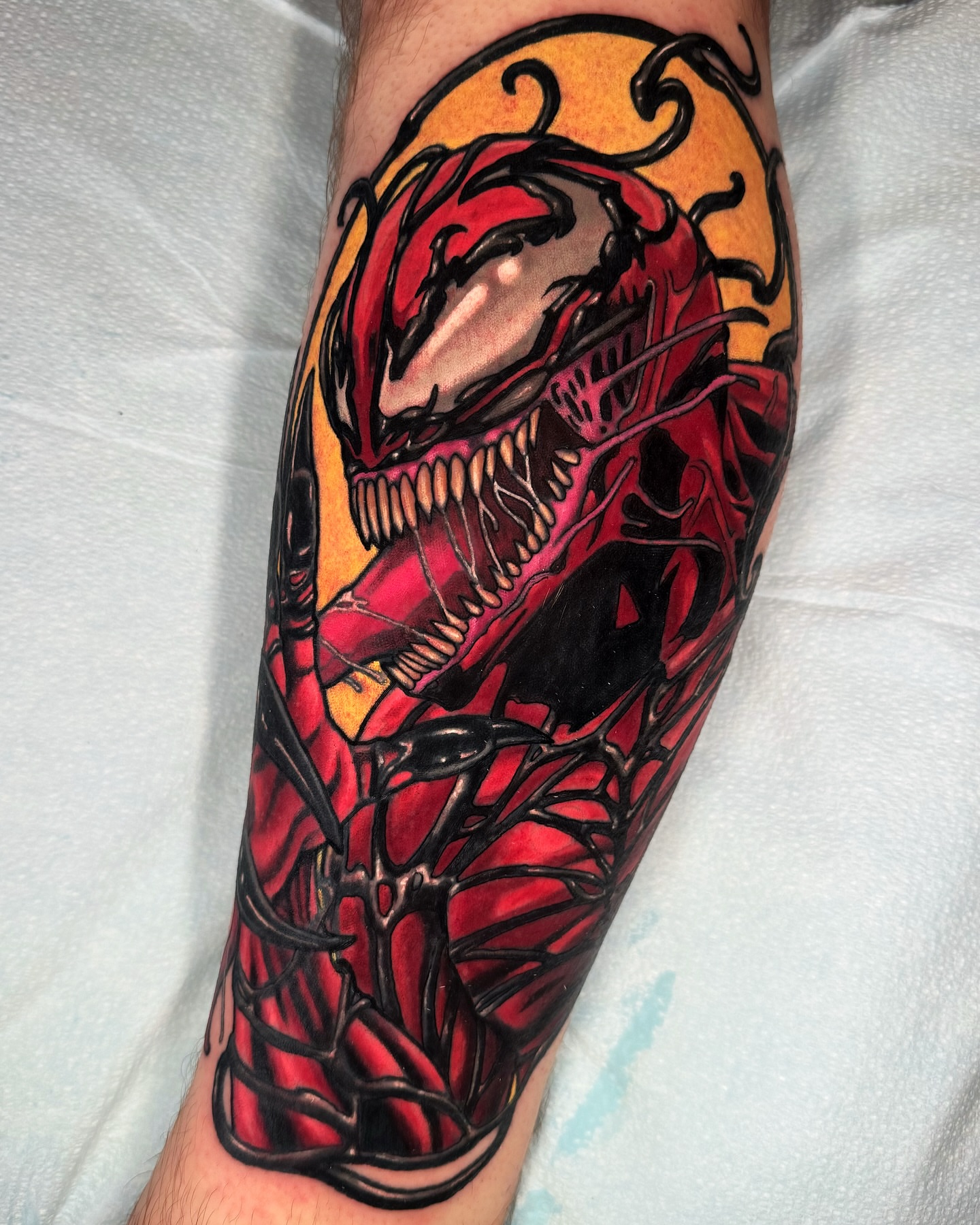 Venom dark realism tattoo on the forearm by Austin Britt