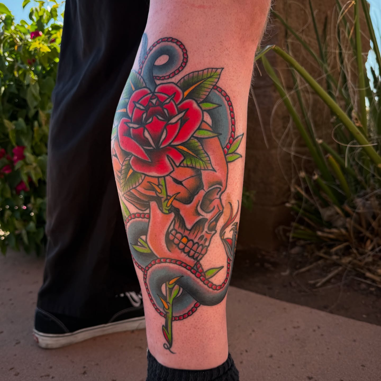 Rose and skull American traditional tattoo on the calf by Donovan hernandez