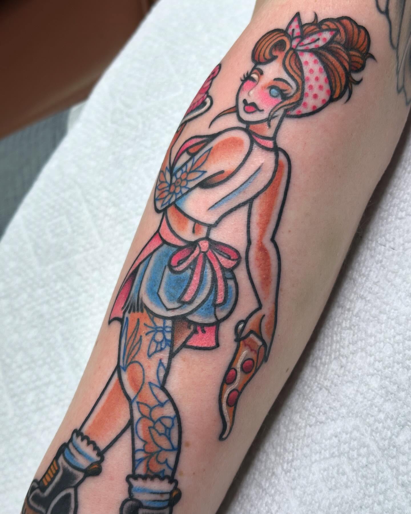 Pin-up girl American traditional tattoo on the forearm by Ginny Marie Kalnasy