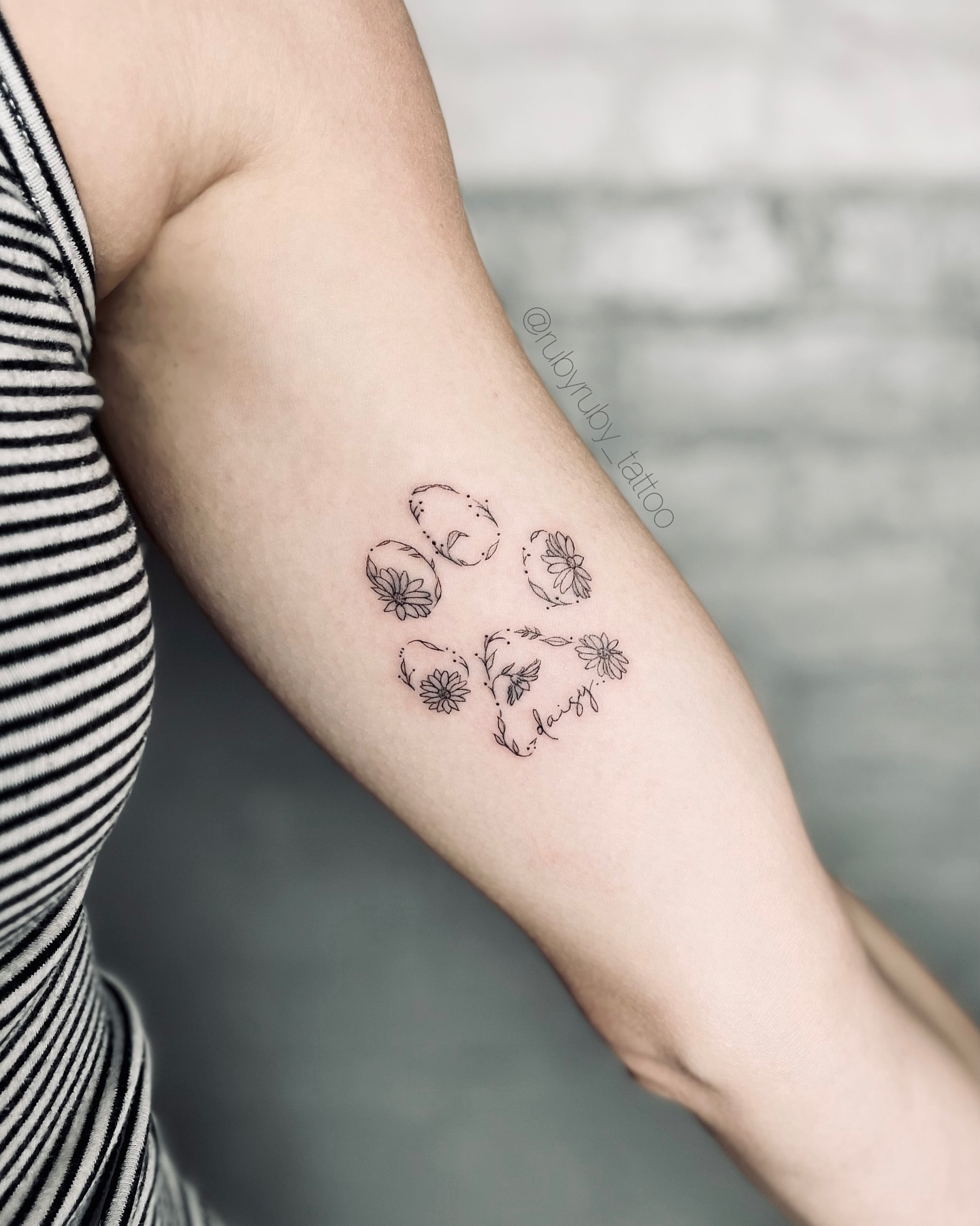 Flower and paw print fine line tattoo on the forearm by Ruby ♥️