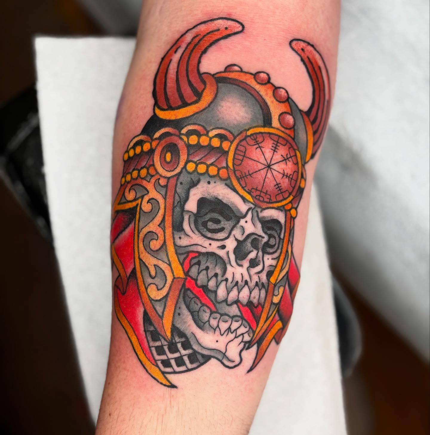 Skull with helmet neo-traditional tattoo on the forearm by Cody Collins