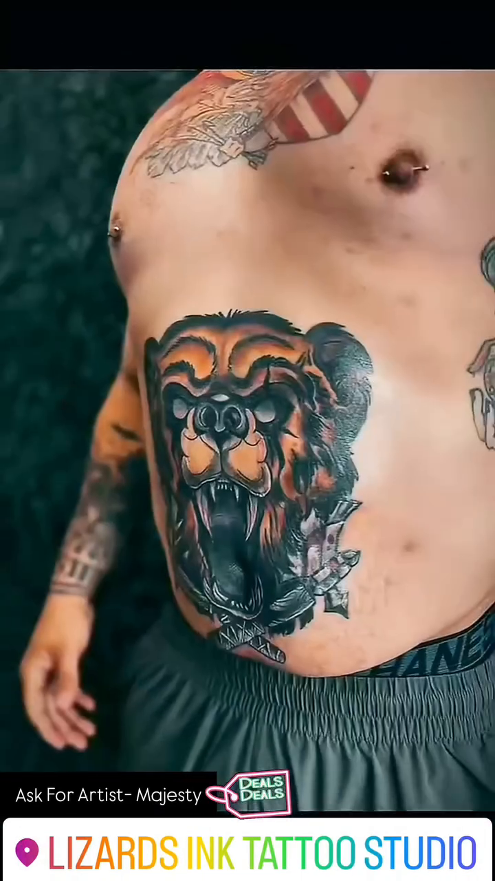 Roaring bear head with floral elements realism tattoo on the chest by Majesty Selvera