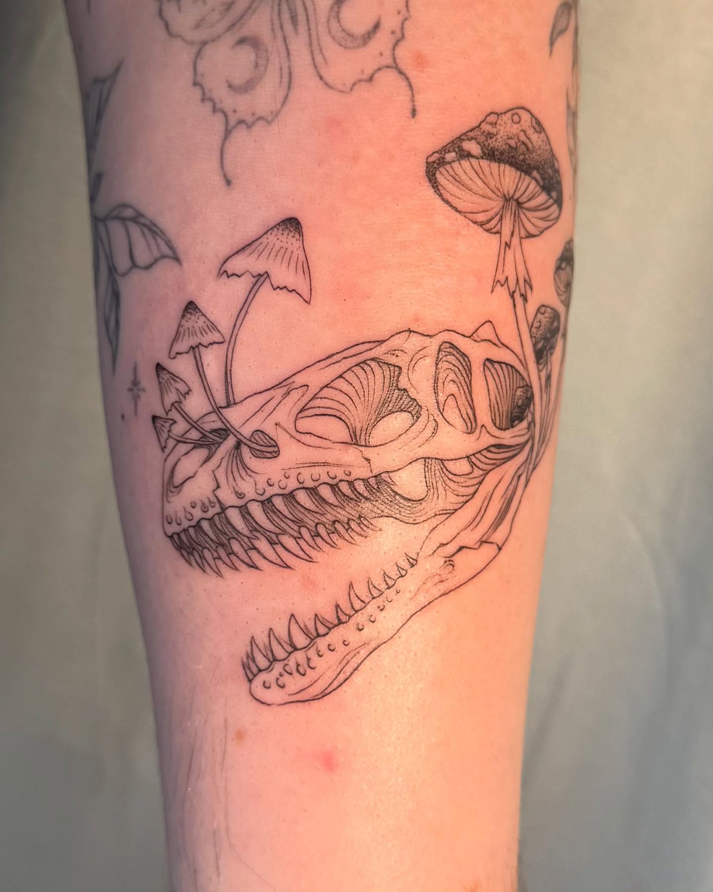 Dinosaur skull black and grey tattoo on the forearm by RyAnn Lynn