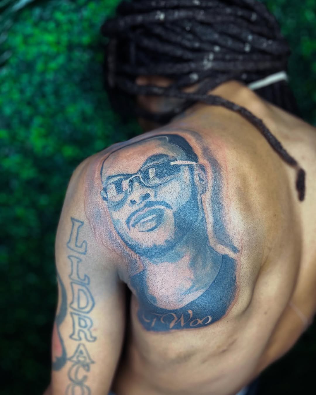 Portrait of a man with glasses realism tattoo on the shoulder by Uncle Fade Tattoo Artist ✍🏾