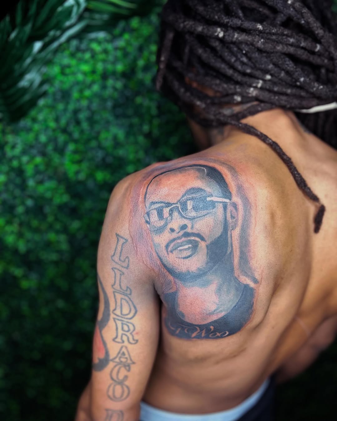 Portrait of a man with glasses realism tattoo on the shoulder by Uncle Fade Tattoo Artist ✍🏾