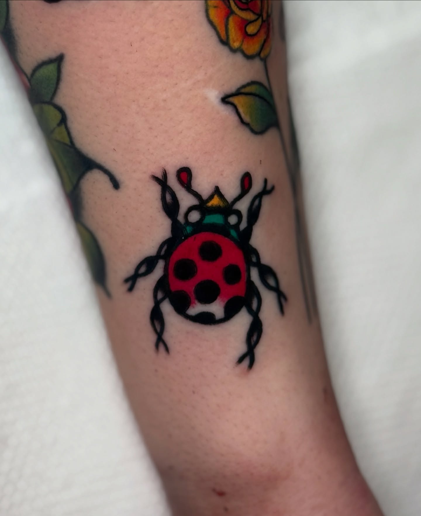 Ladybug American traditional tattoo on the forearm by οΌππ¨ππ¨οΌ, New York, New York