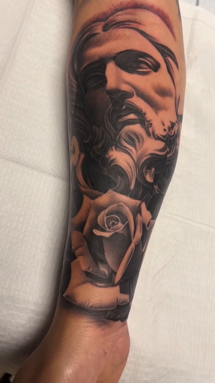 Man's bust and rose realism tattoo by Antonio Pavić, Los Angeles, California