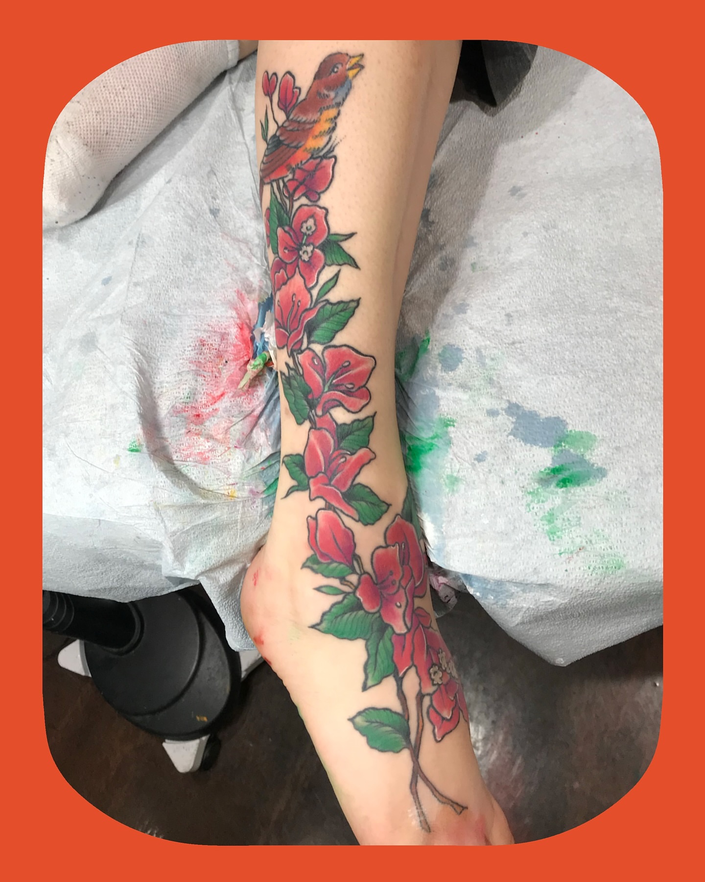 Bird and flowers American traditional tattoo on the foot by Chris Chapman