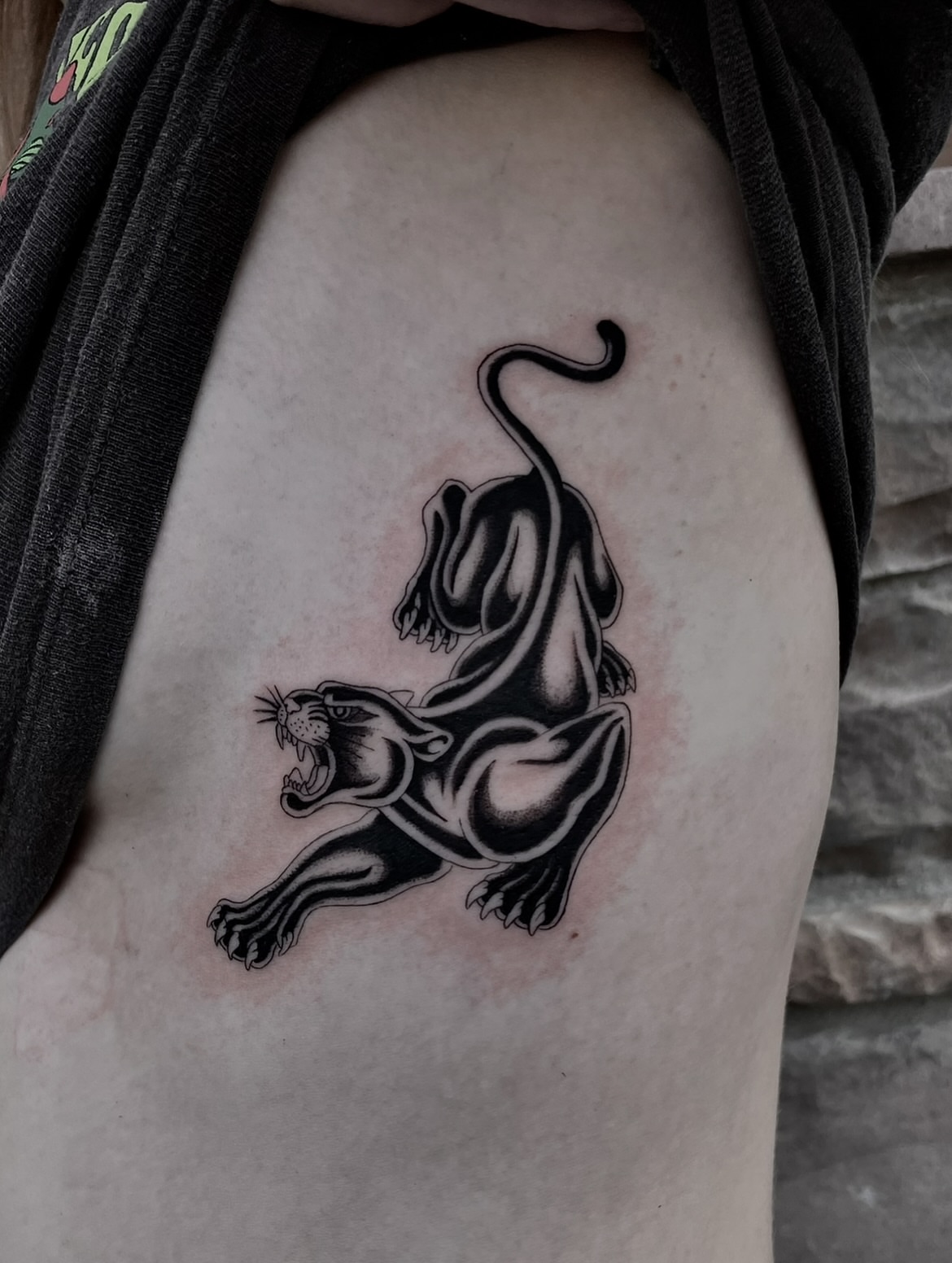 Panther black and grey tattoo on the thigh by Tattoo Artist