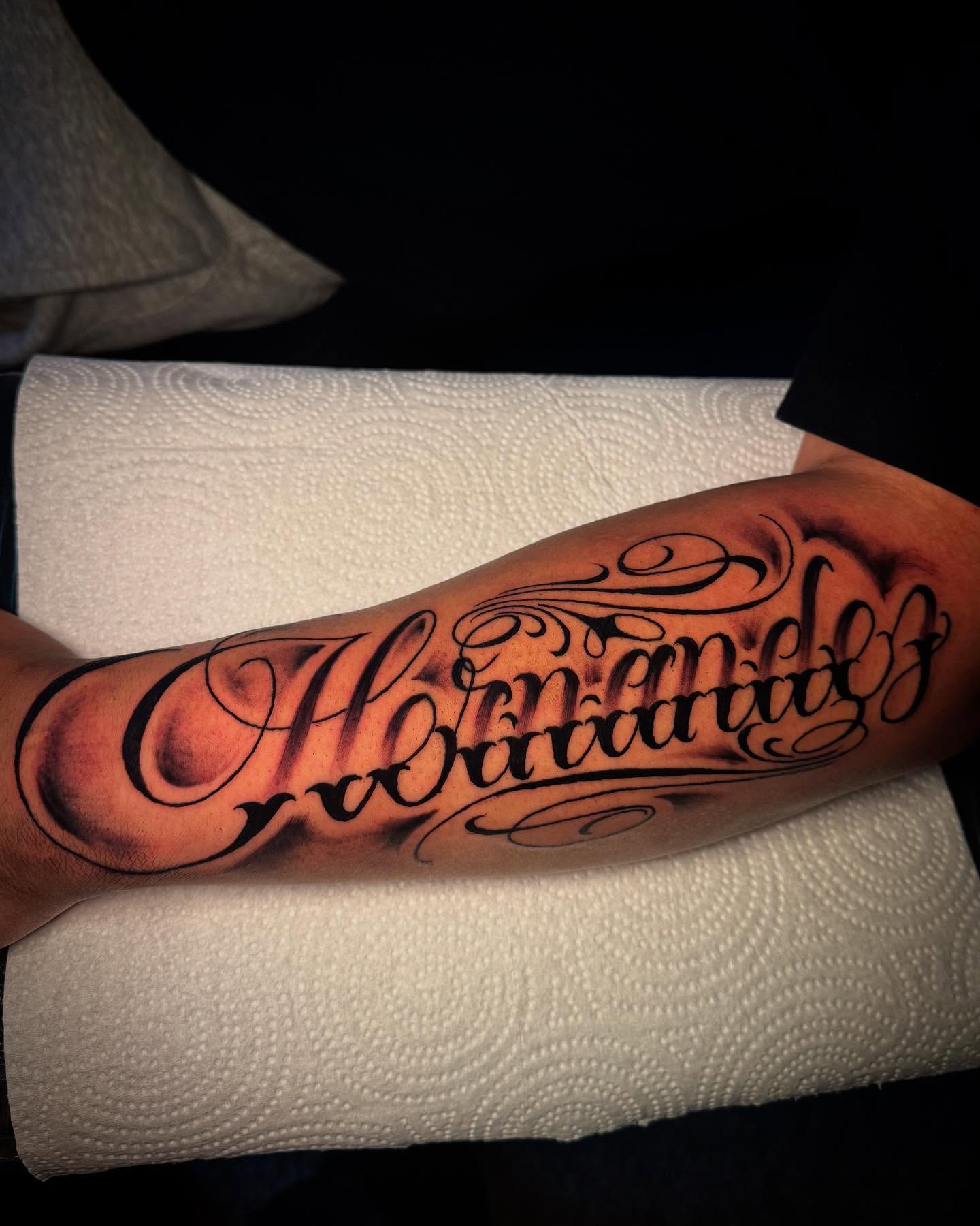 Script lettering lettering script tattoo on the forearm by Tattoo Artist based in Dallas Tx