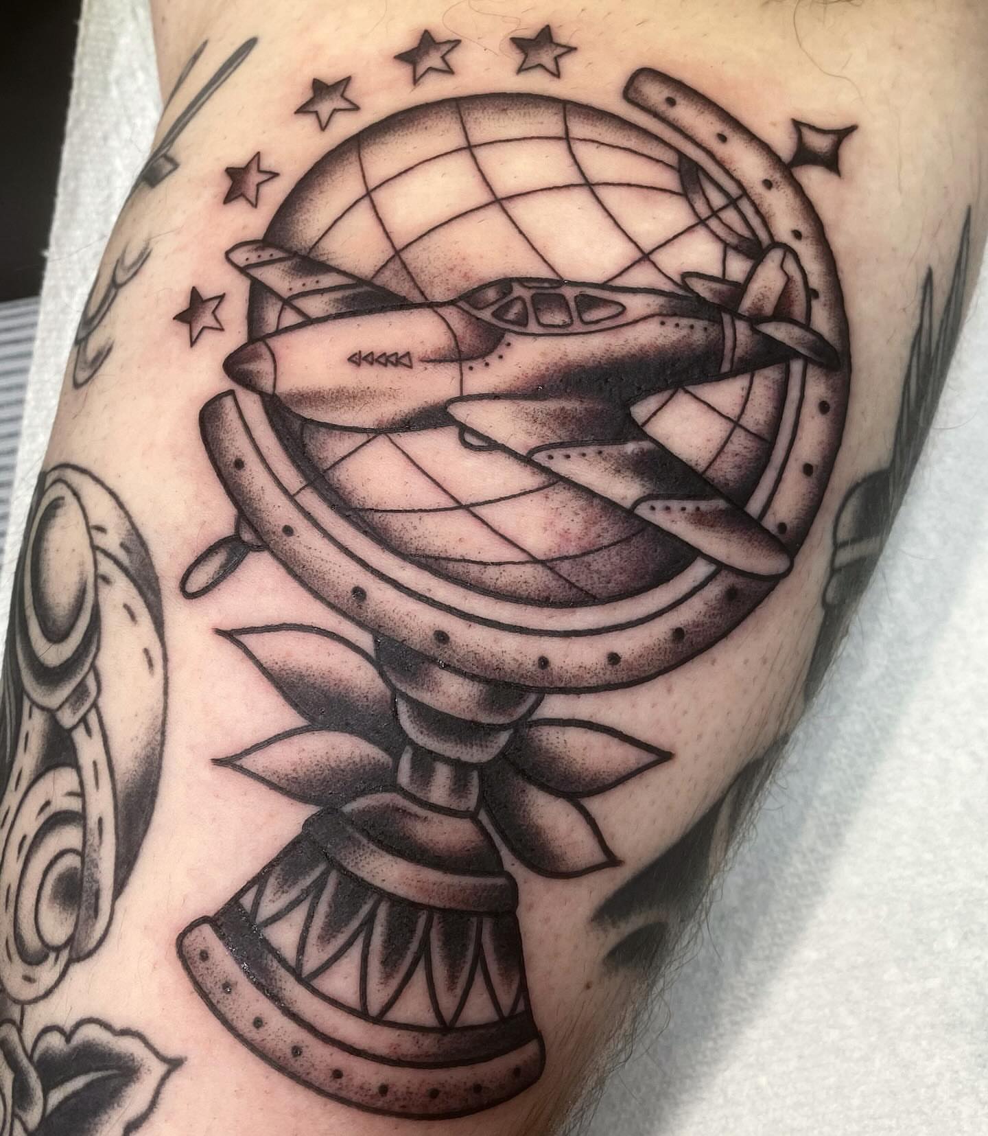 Airplane globe black and grey tattoo on the forearm by Kiera ❤️‍🔥