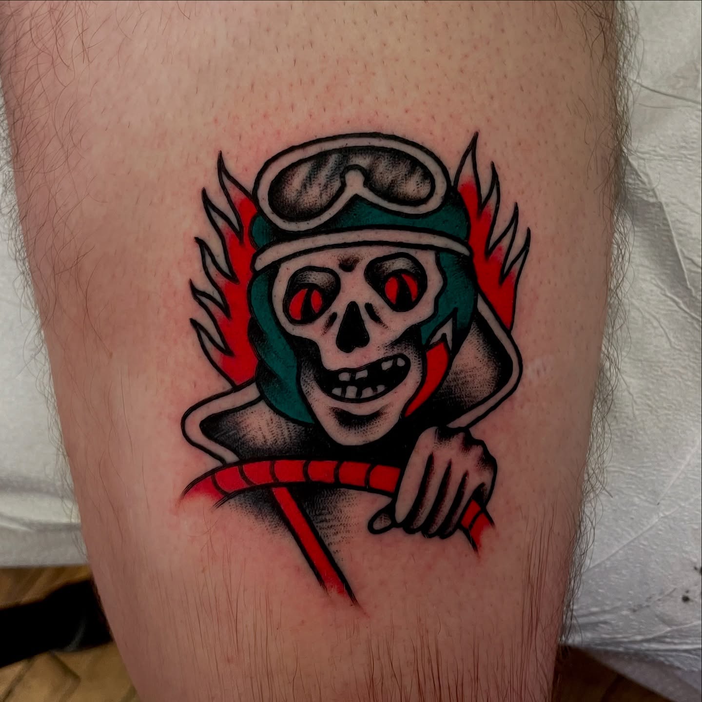 Skull wearing goggles American traditional tattoo on the thigh by Texas Jonah